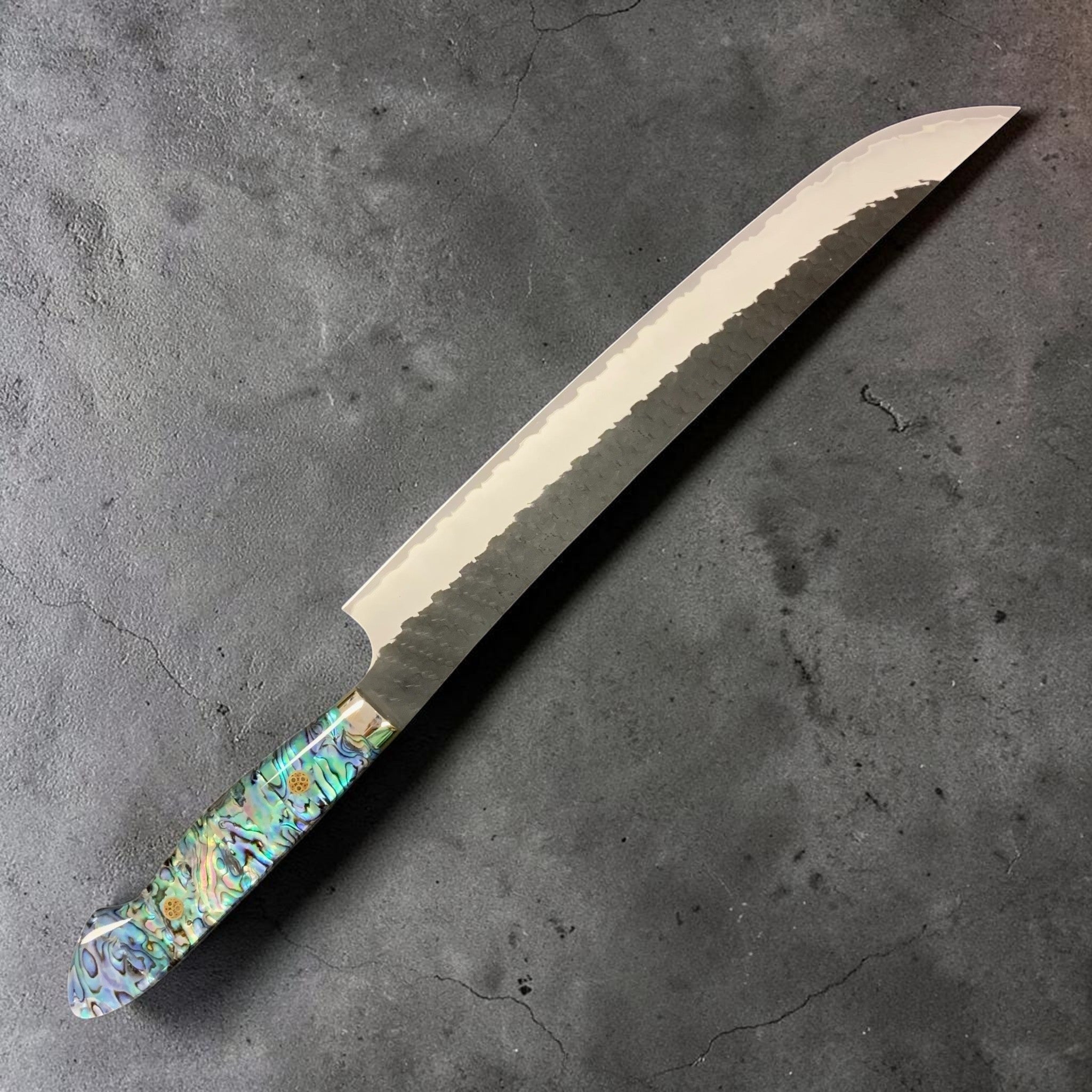 Nigara Hamono SG2 Kurouchi Tsuchime Sujihiki 270 mm, left side profile with abalone Western handle.
