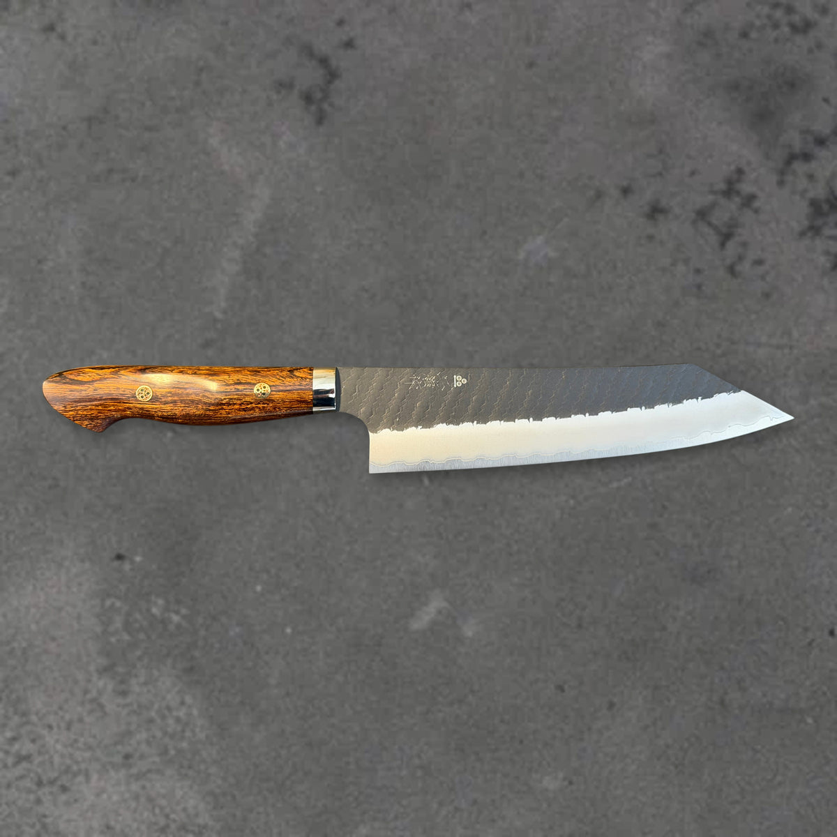 Nigara SG2 Kurouchi Tsuchime 210mm kiritsuke with ironwood handle, shown in horizontal front profile with the full blade and handle visible.