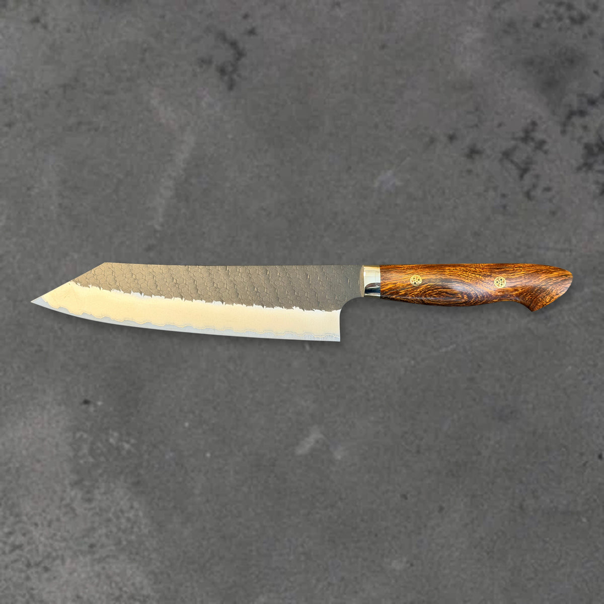 Nigara SG2 Kurouchi Tsuchime 210mm kiritsuke with ironwood handle, shown in horizontal reverse profile with the full blade and handle visible.