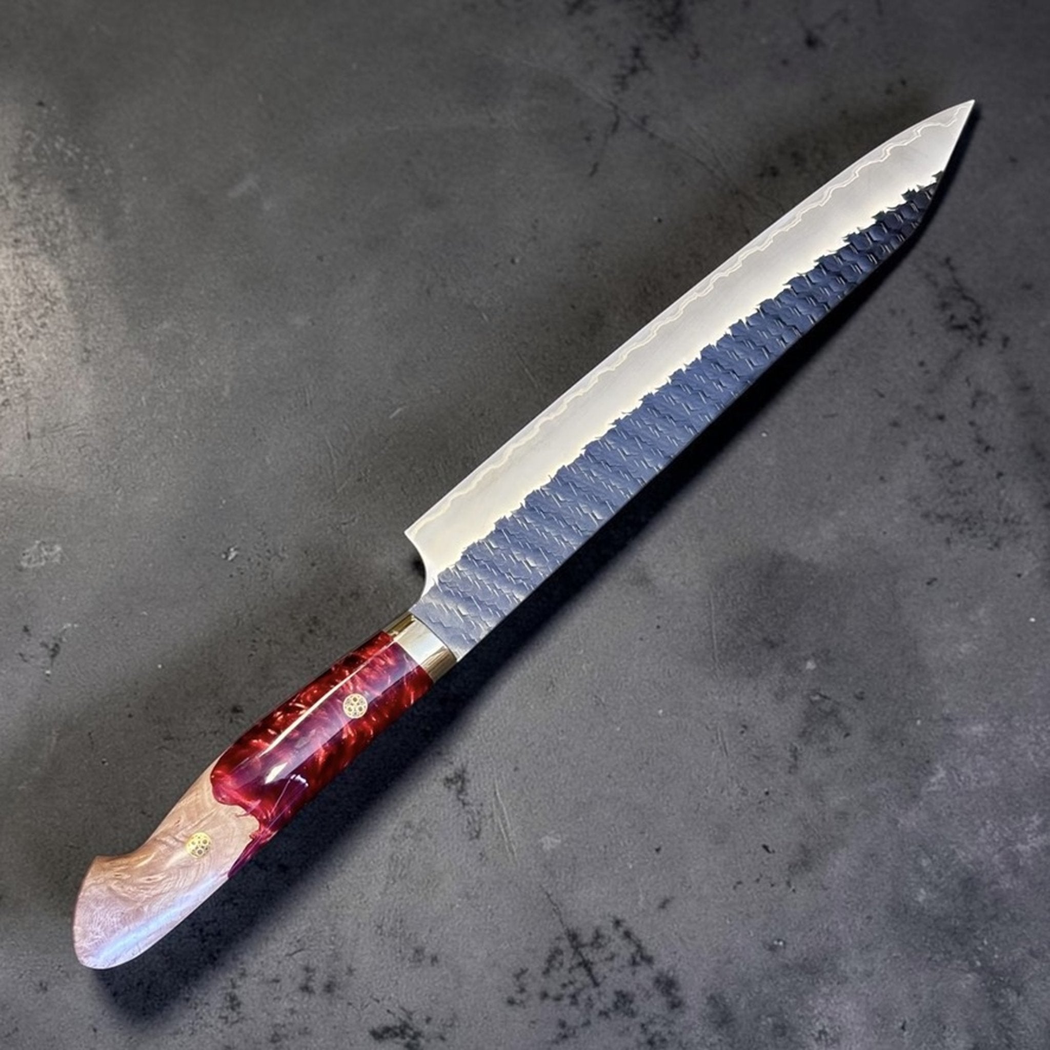 Nigara SG2 Kurouchi Tsuchime Sujihiki 255 mm with hybrid western handle, angled product view showing blade length and red resin handle.