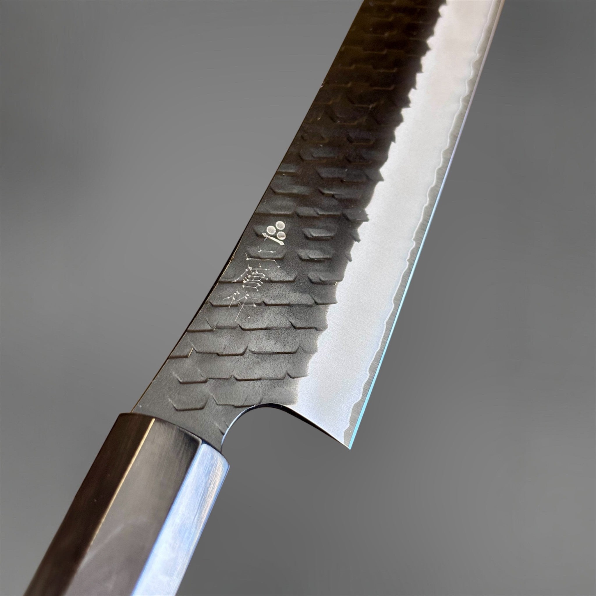 Nigara SG2 Tsuchime Kurouchi Sakimaru Sujihiki 270 mm, close-up of the blade face showing Nigara kanji, hammered tsuchime texture, kurouchi finish, and bright polished edge.