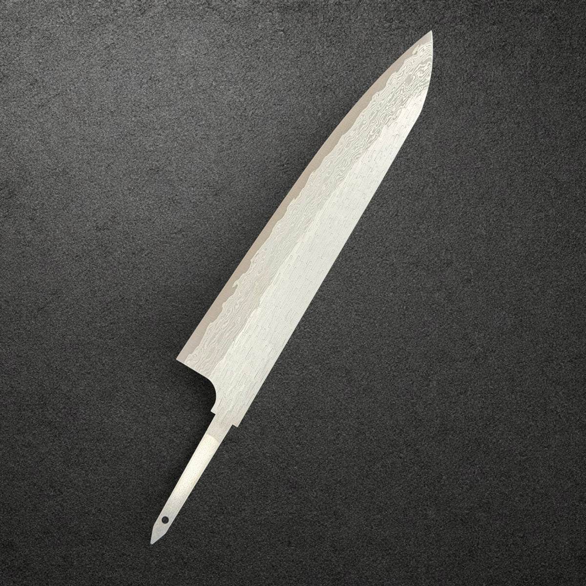 Nigara VG-XEOS Tsuchime Gyuto 240mm blade only, reverse angled view showing Damascus layers and exposed tang.