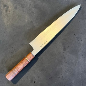 Satoshi Nakagawa Blue #1 Damascus Gyuto 240mm with one-of-one Prisma handle, angled product view.