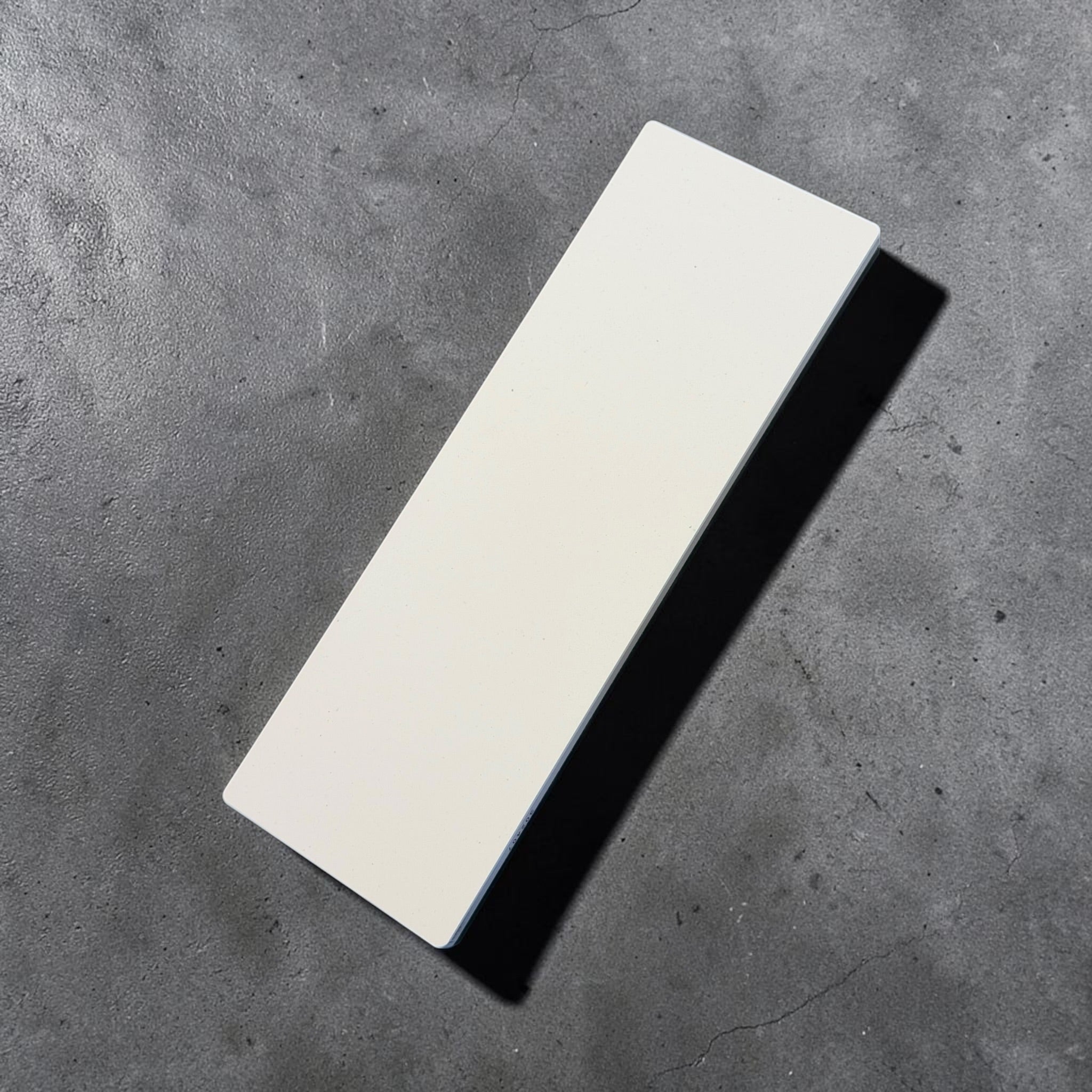 Shapton GlassStone 4000 grit ceramic whetstone top surface on dark background