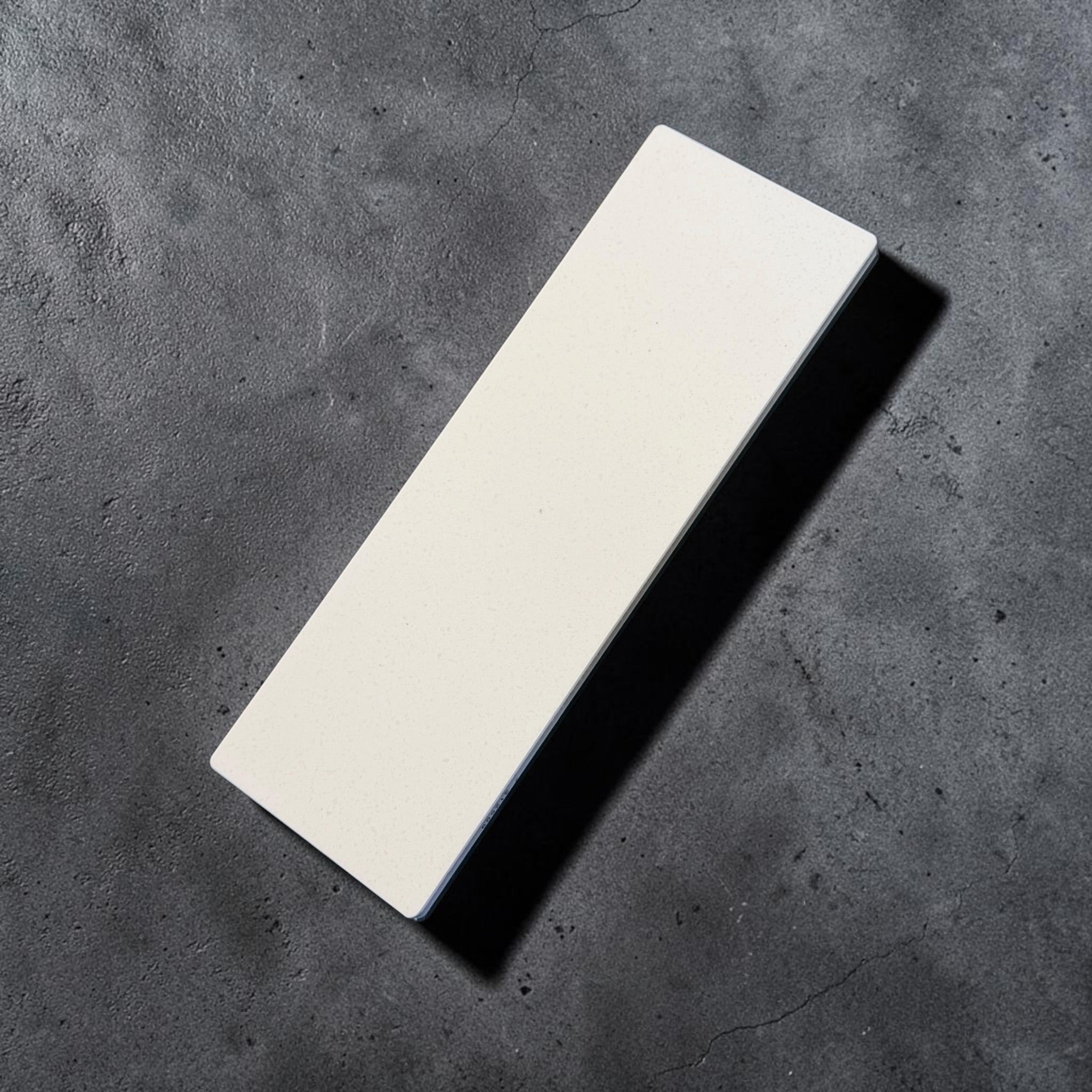 Shapton GlassStone 500 grit ceramic whetstone top surface on dark background