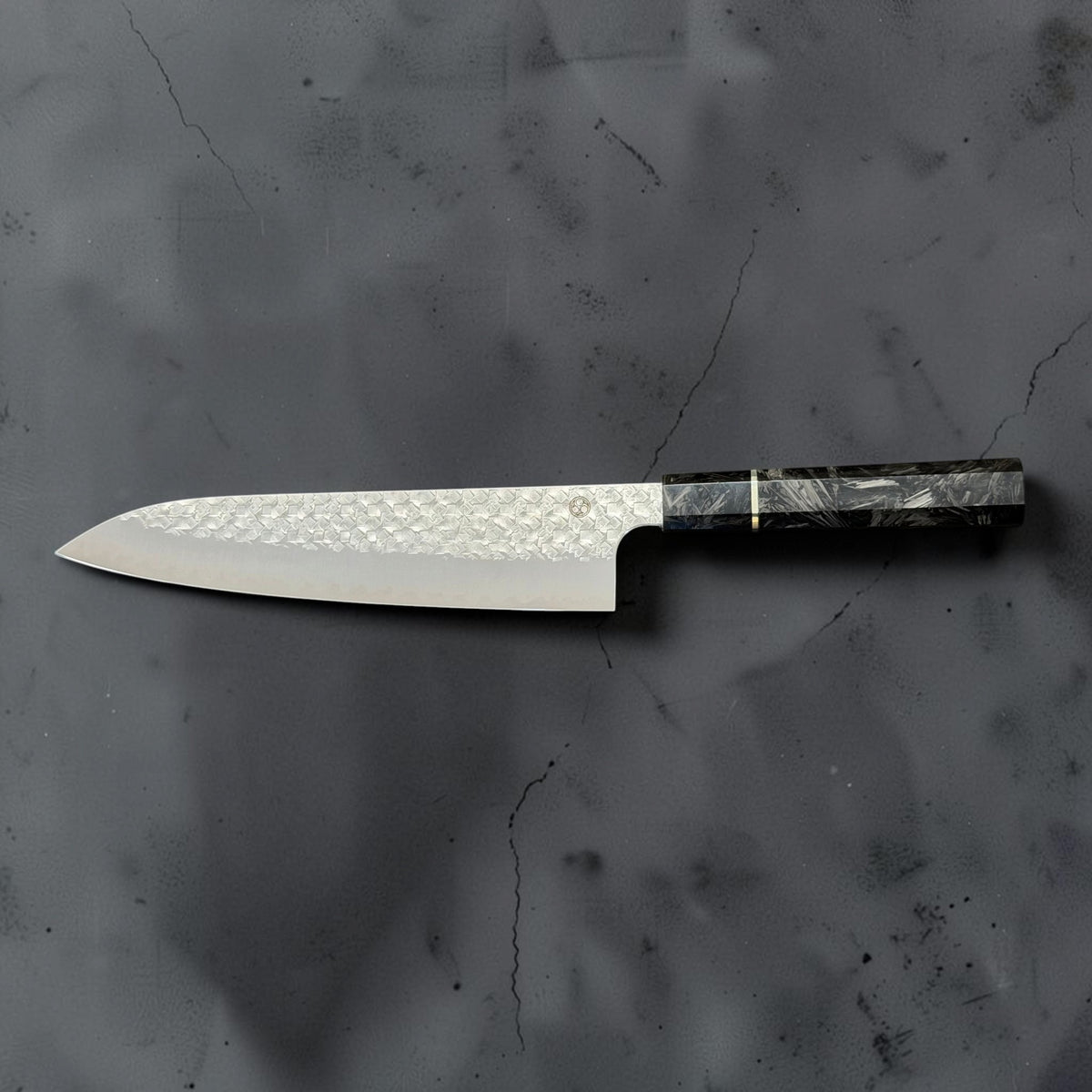 Reverse side profile of the Shibata Arare SG2 gyuto 210mm, showing its curved edge and octagonal carbon fiber handle.