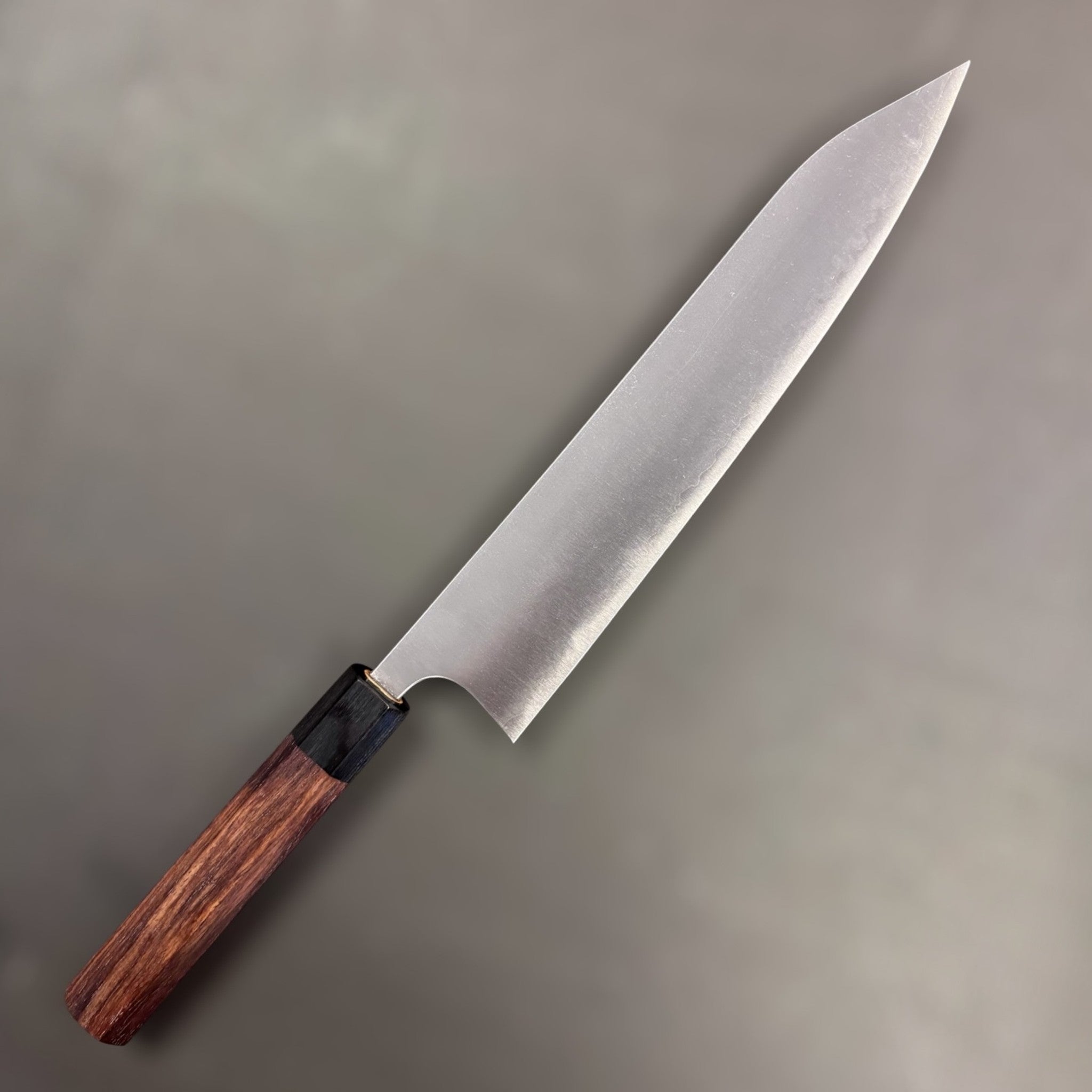 Shibata Koutetsu Aogami Super Gyuto 240 mm, spine thickness view toward the tip on a white background.