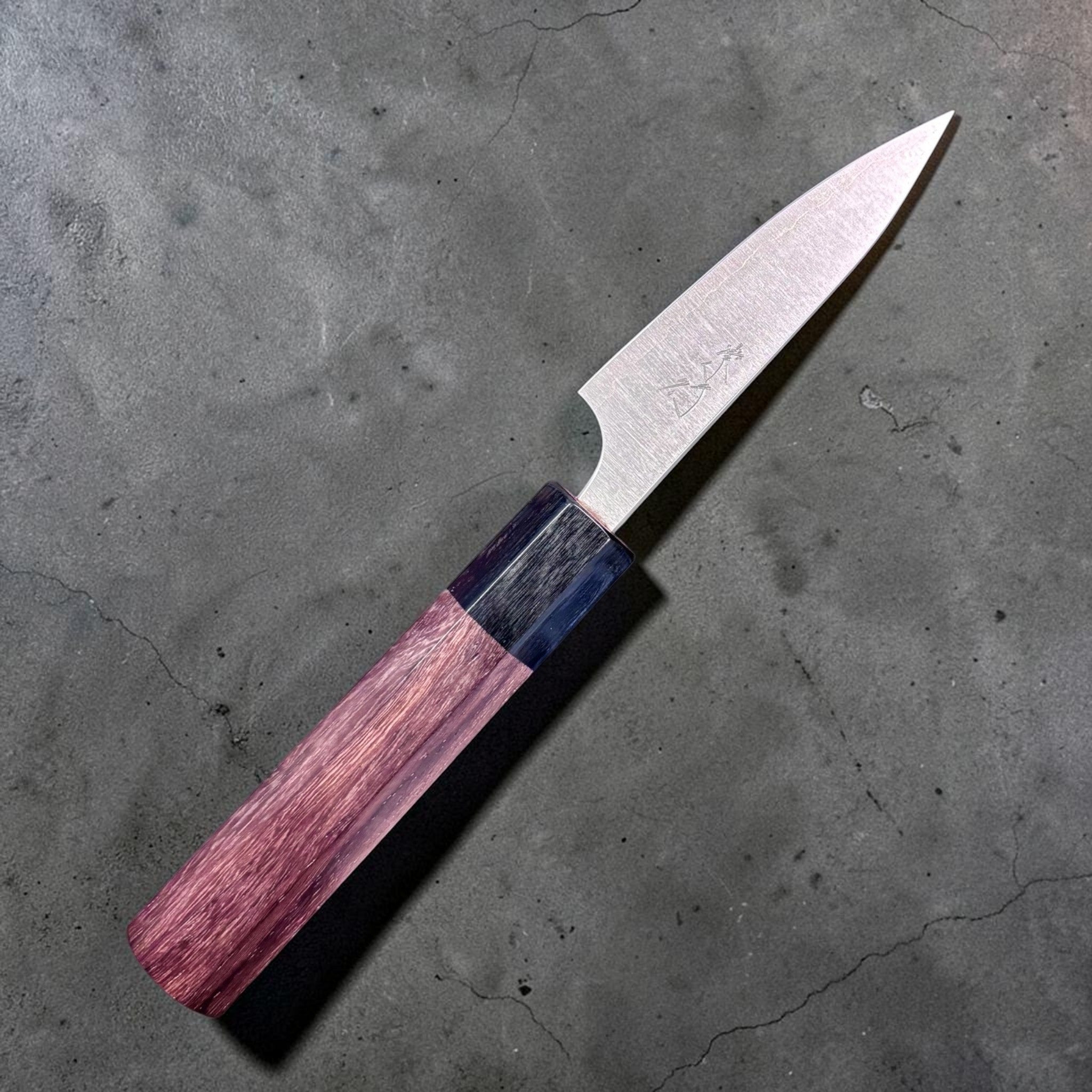 Shibata Koutetsu Aogami Super Migaki Petty 80 mm, left‑side profile with maker’s kanji on blade, walnut handle against black background.