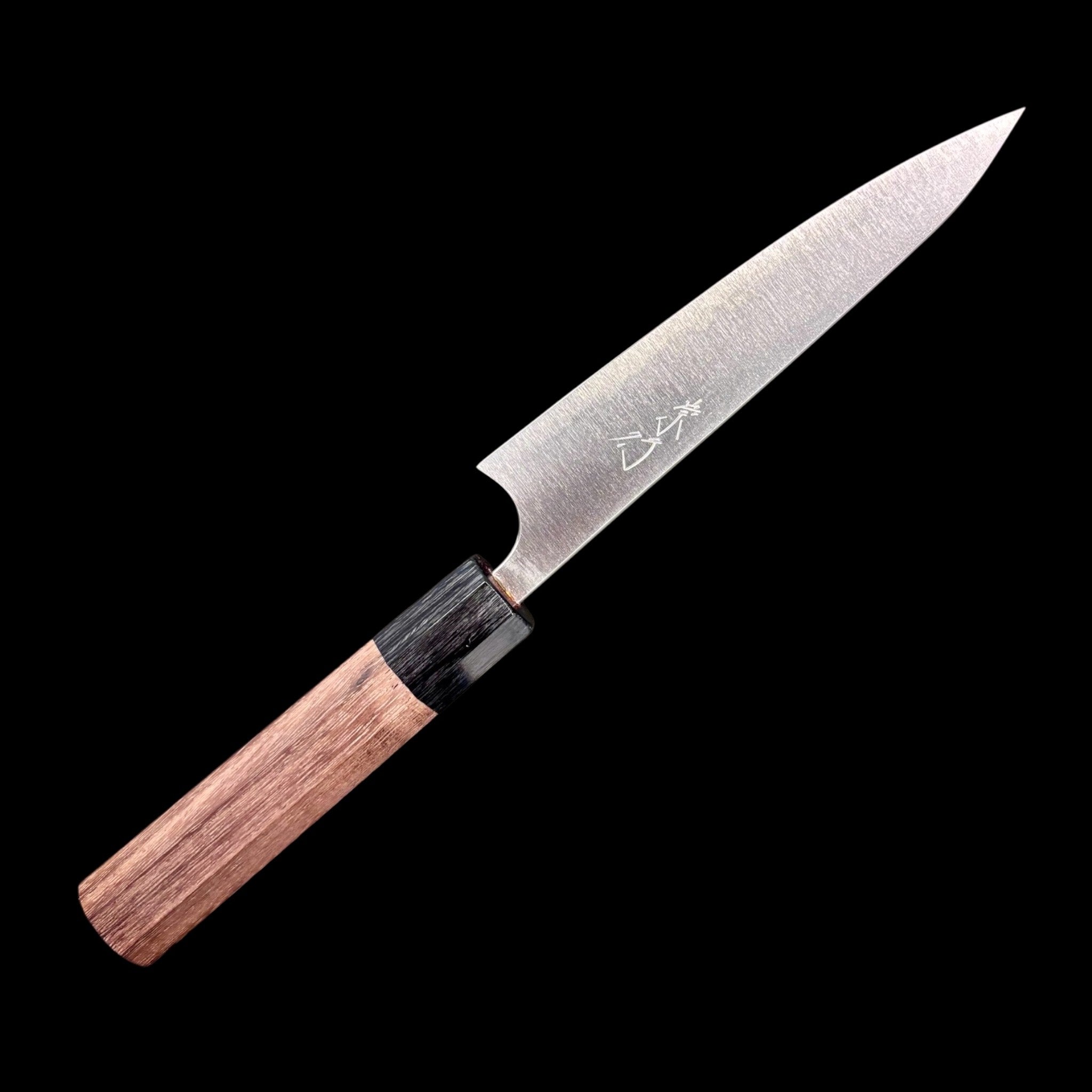 Shibata Koutetsu Aogami Super Petty 135 mm, left‑side profile with maker’s kanji on blade, walnut/ebony wa handle against black background.