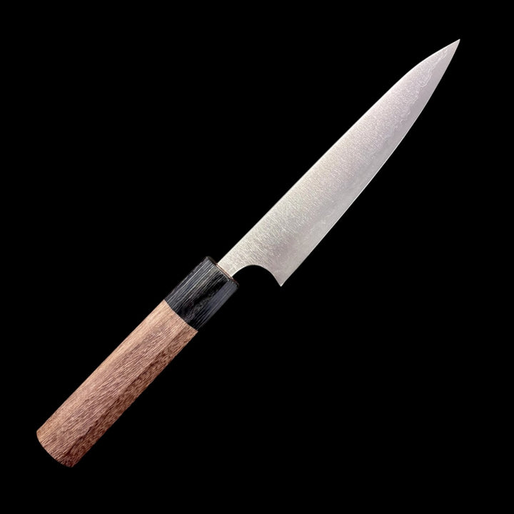 Shibata Koutetsu Aogami Super Petty 135 mm, right‑side profile showing walnut/ebony wa handle and hazy migaki blade.