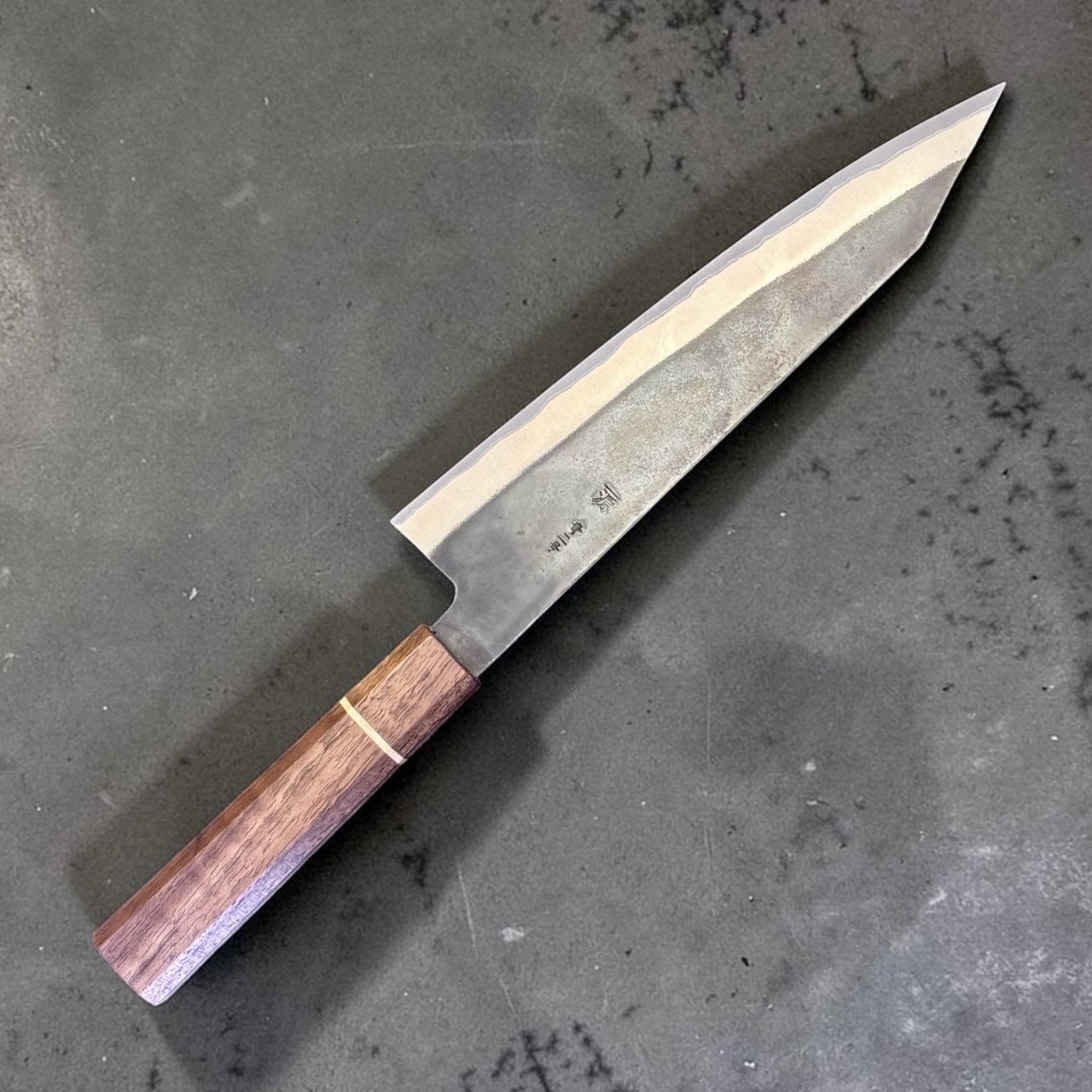 Shigeki Tanaka Stainless-Clad Blue #2 Kurouchi Kiritsuke 210 mm, angled blade and Sanjo walnut handle view.