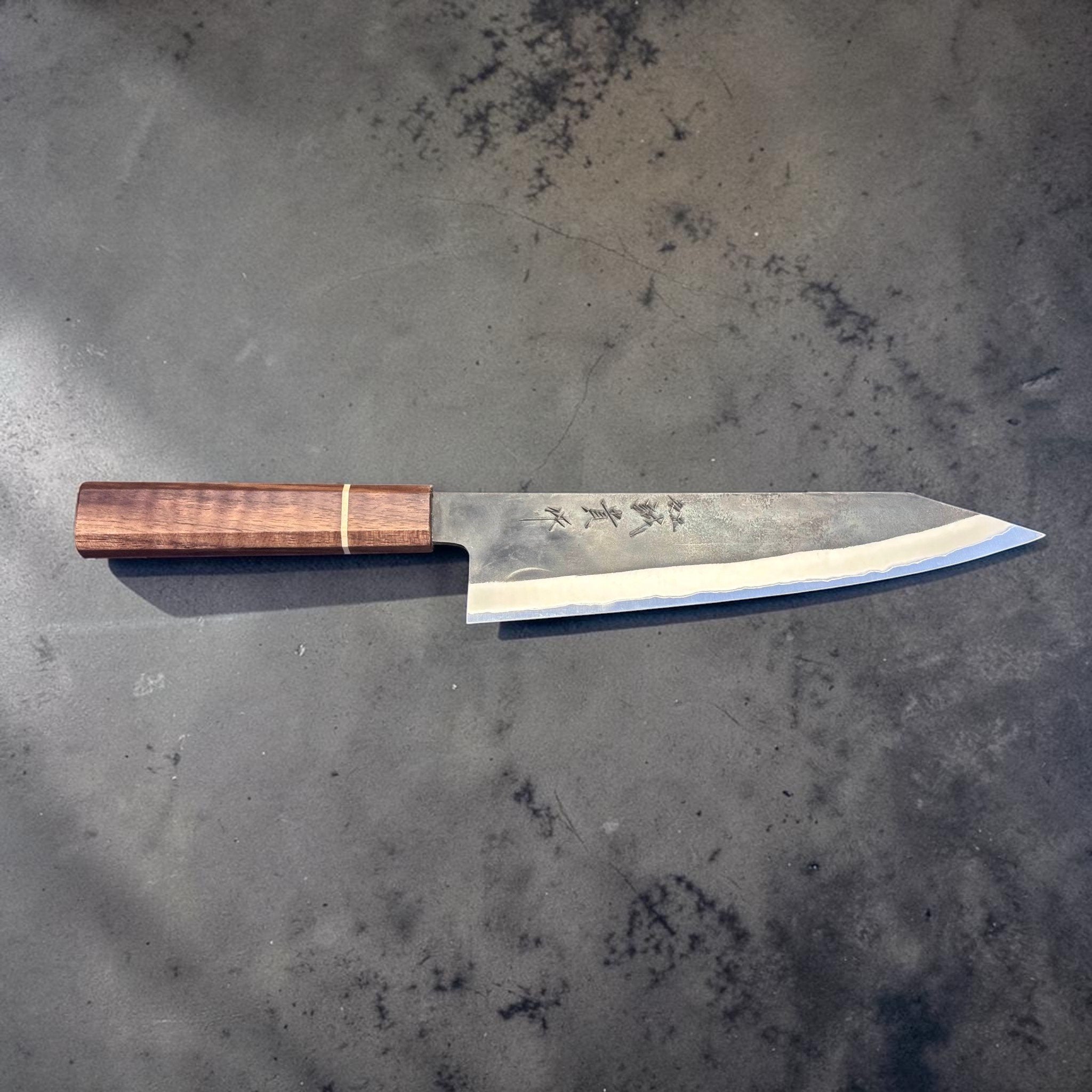 Shigeki Tanaka Stainless-Clad Blue #2 Kurouchi Kiritsuke 210 mm, flat profile showing kurouchi finish and polished edge bevel.
