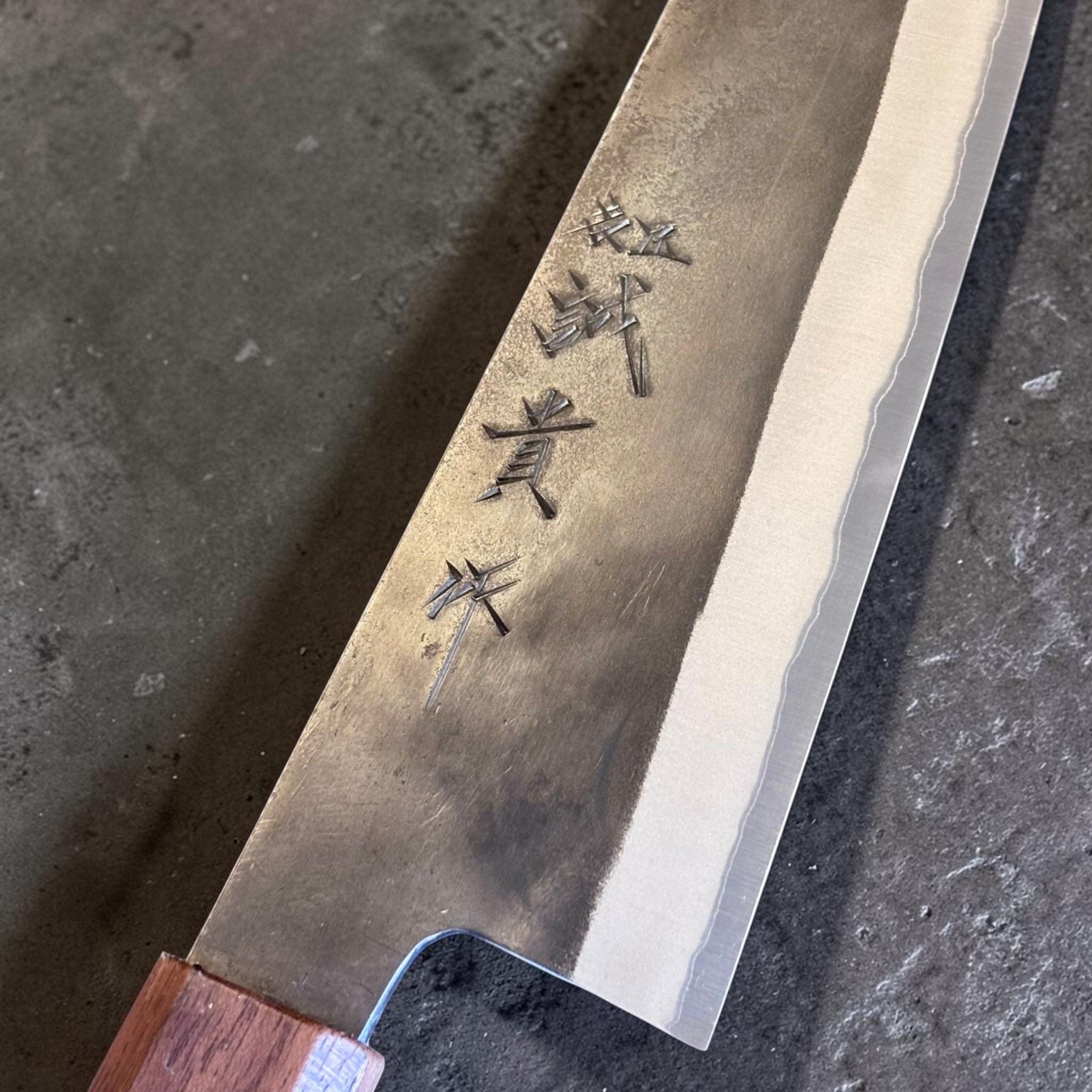 Shigeki Tanaka Stainless-Clad Blue #2 Kurouchi Kiritsuke 210 mm, close-up of kanji and stainless-clad Blue #2 blade finish.
