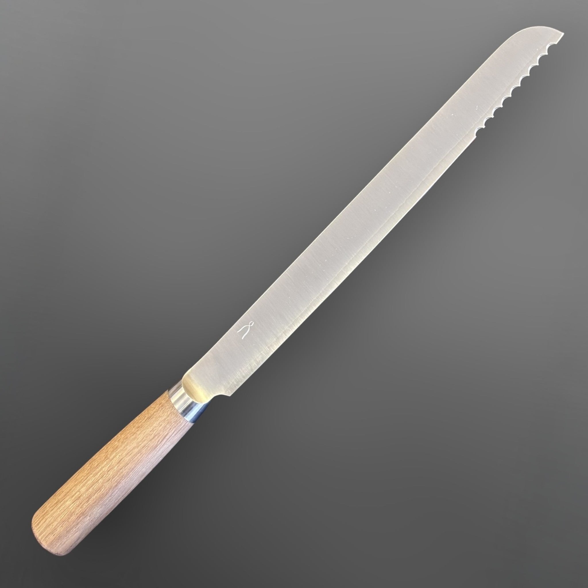 Tadafusa SLD Bread Knife with light wood handle, angled full-profile view showing the serrated tip section.