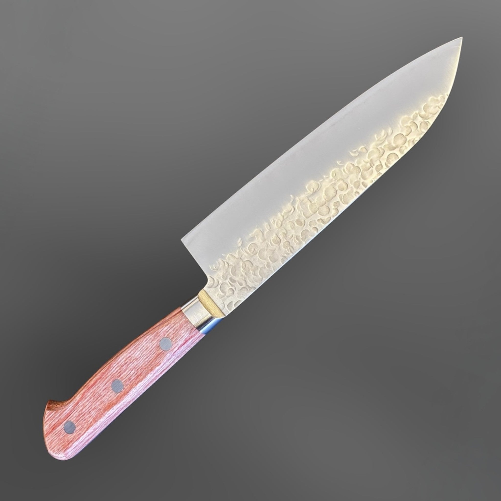 Takamura Chromax Santoku 170 mm, angled full-knife view with hammered blade finish and western handle.