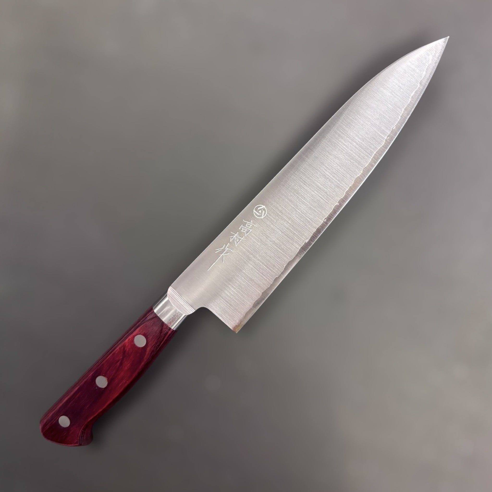 Takamura SG2 Gyuto 180 mm, right-side face showing grind and brushed finish; red Western handle.