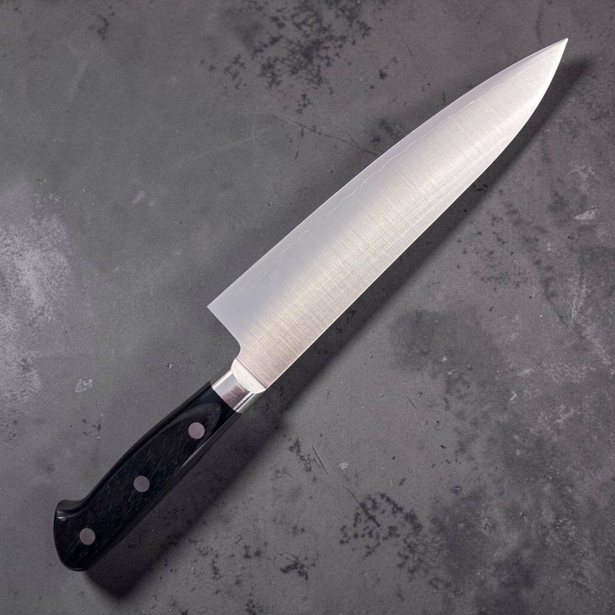 Takamura VG-10 Migaki Gyuto 180 mm, left side profile of polished blade with triple-rivet black Western handle.