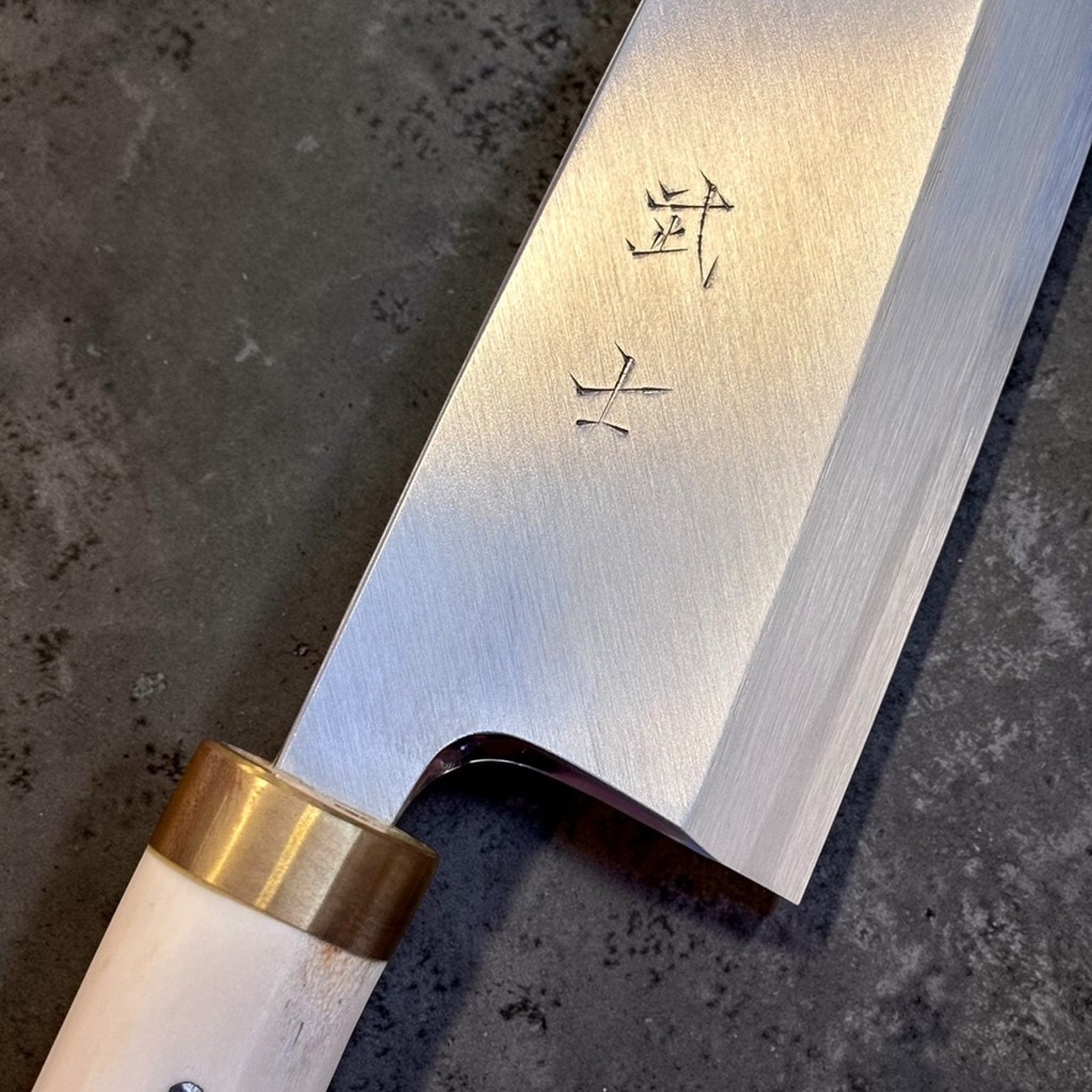 Takeshi Saji Ginsan #3 Deba 105 mm with deer antler handle, close-up of blade engraving and brass ferrule.