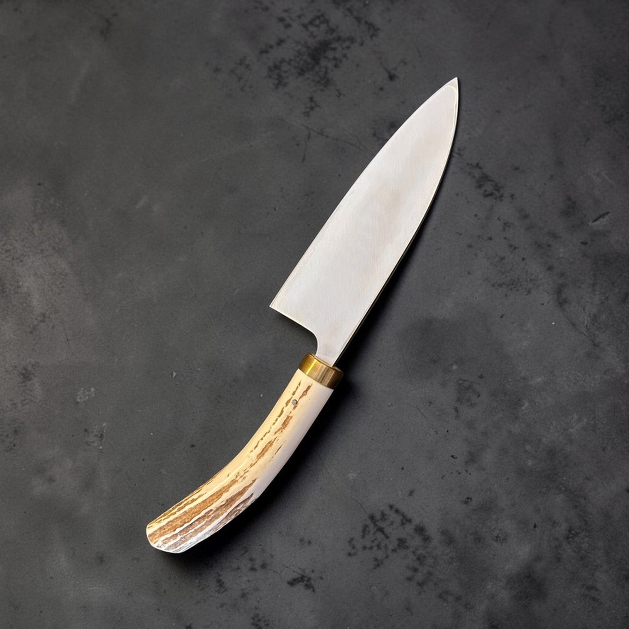 Takeshi Saji Ginsan #3 Deba 105 mm with deer antler handle, angled view highlighting the curved antler handle.