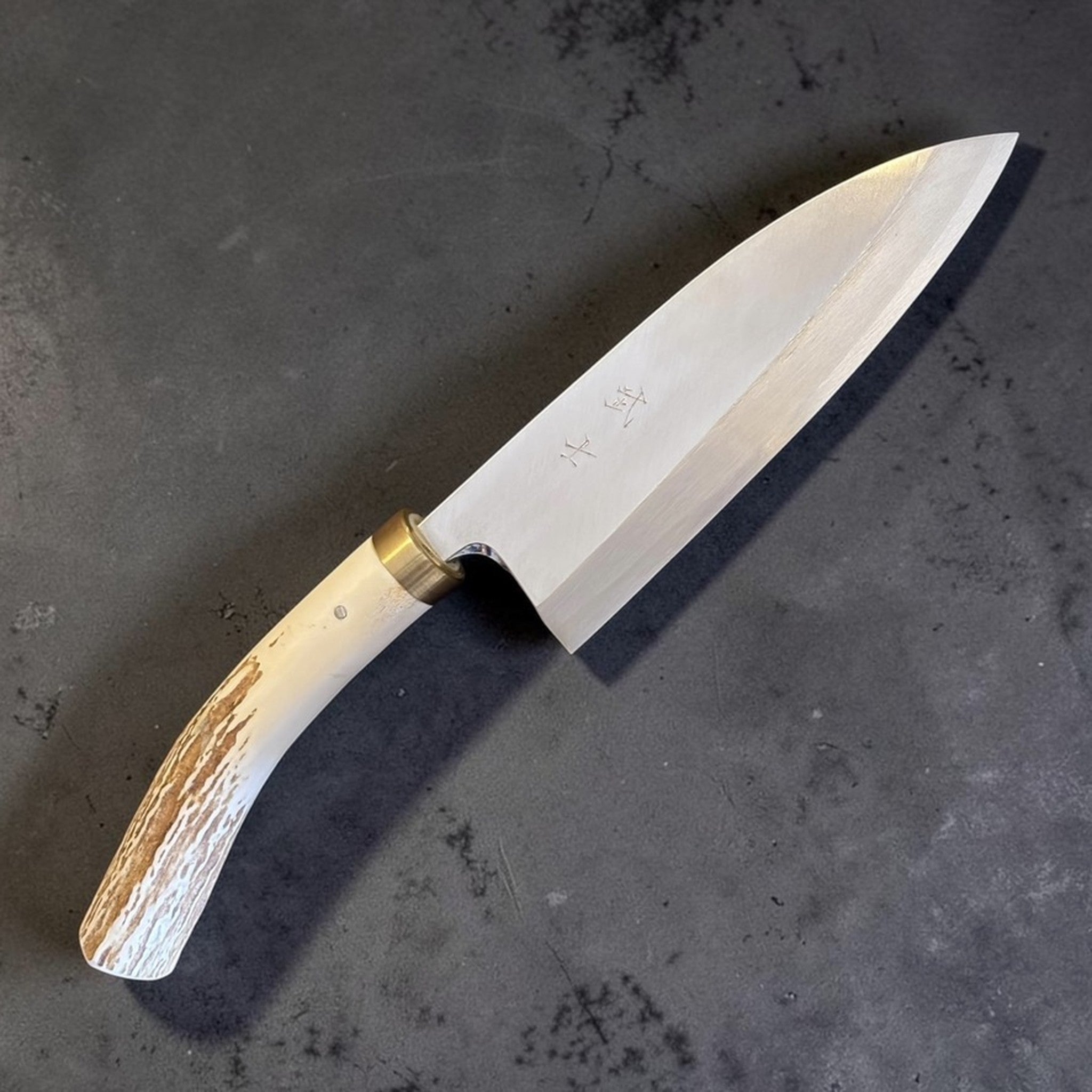 Takeshi Saji Ginsan #3 Deba 105 mm with deer antler handle, angled blade view with brass ferrule and engraved kanji.