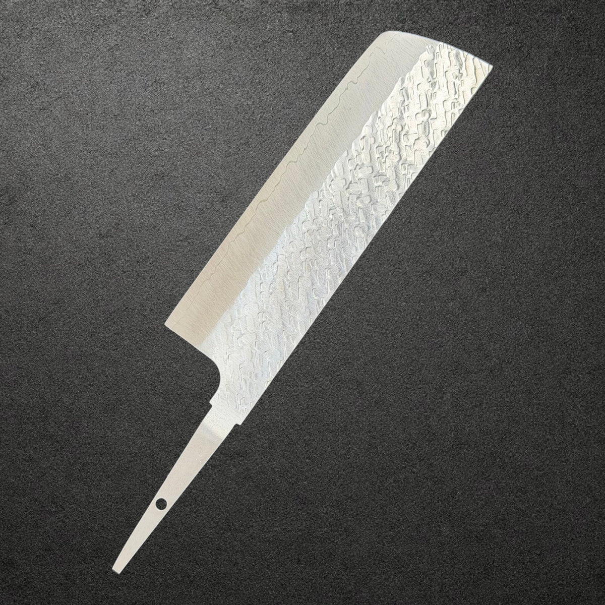 Reverse angled view of Takeshi Saji STRIX Tsuchime Nakiri blade only with stainless cladding and an exposed tang.
