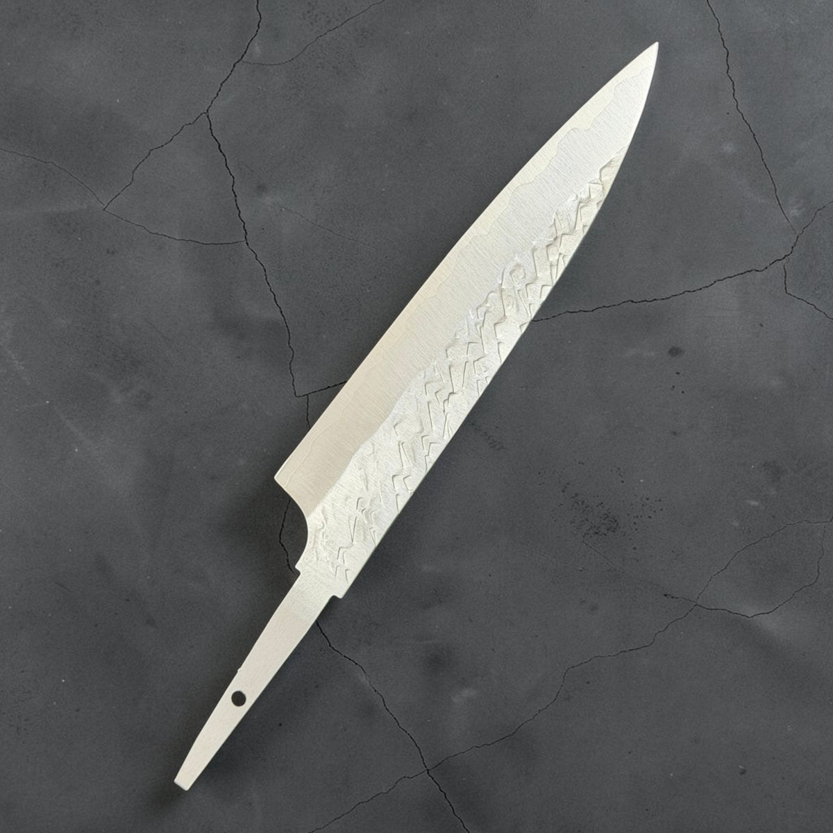 Reverse angled view of Takeshi Saji STRIX Tsuchime Petty 130mm blade only with stainless cladding and an exposed tang.