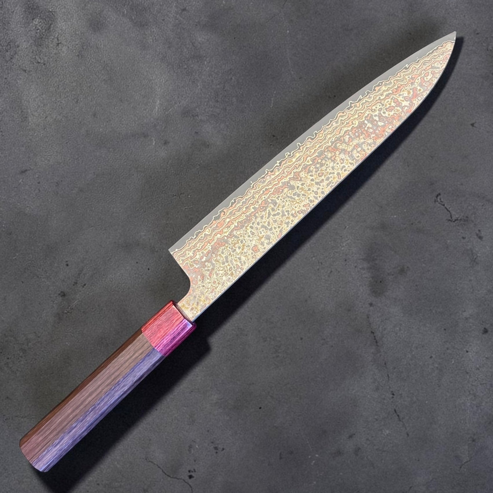 Takeshi Saji VG-10W Nashiji Rainbow Gyuto 240mm, opposite diagonal view showing rainbow Damascus blade and rosewood handle.