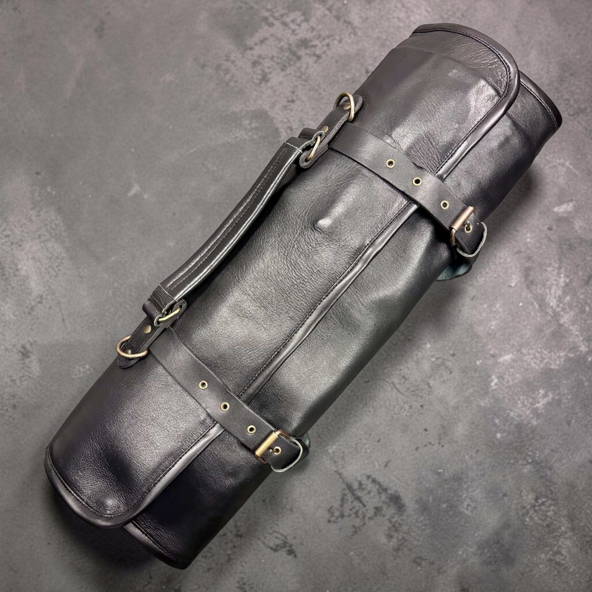 Tokushu Knife Premium Leather Knife Roll rolled up and secured with adjustable straps and shoulder handle