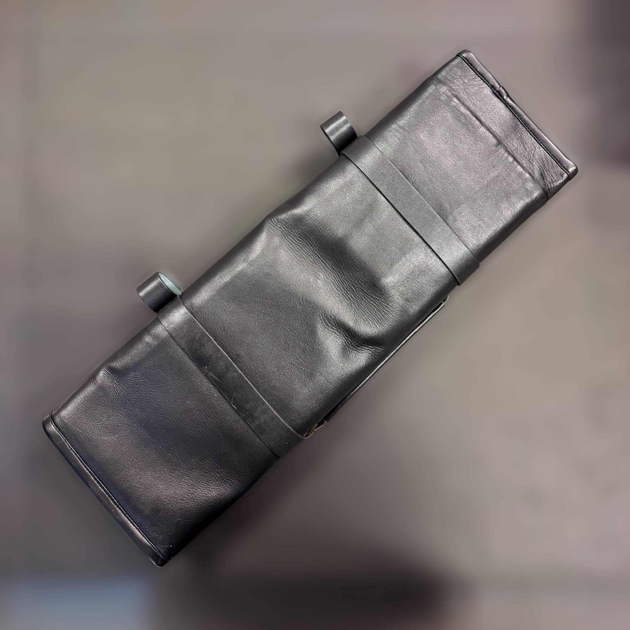 Tokushu Knife Premium Leather Knife Roll top-down view of the closed roll in smooth black leather