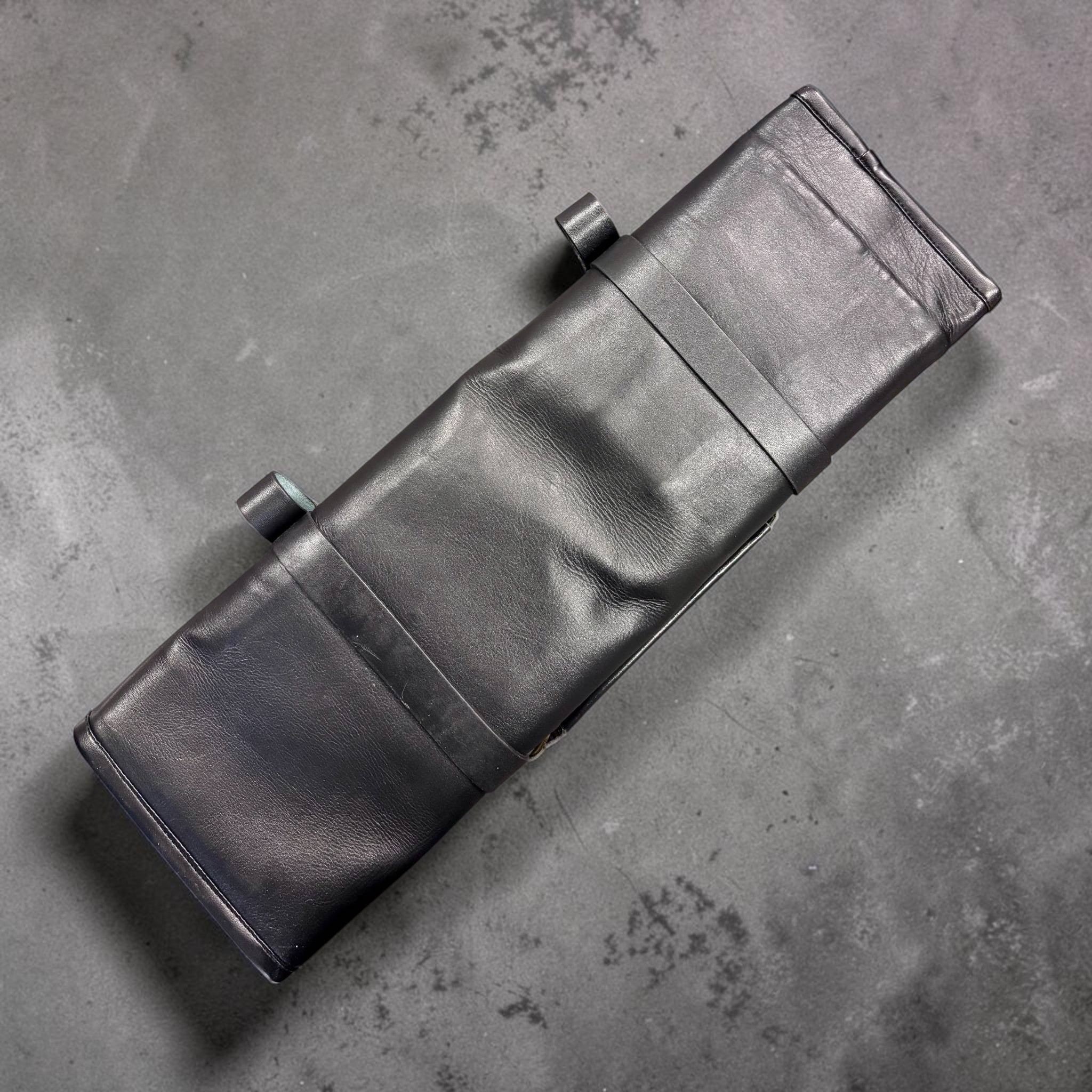 Tokushu Knife Premium Leather Knife Roll top-down view of the closed roll in smooth black leather