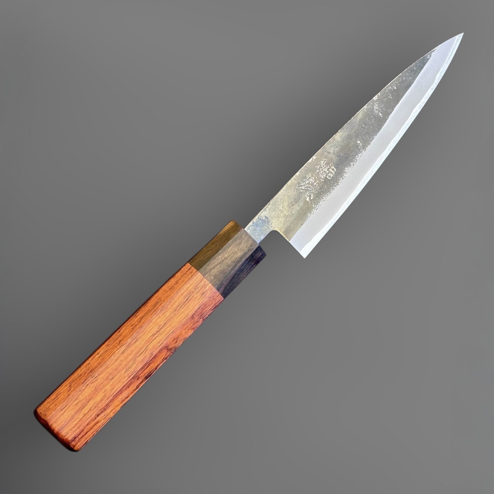 Tokushu Knife Rosewood Series White #2 Kurouchi 135 mm Japanese petty knife, angled front view showing kurouchi finish and rosewood wa handle.