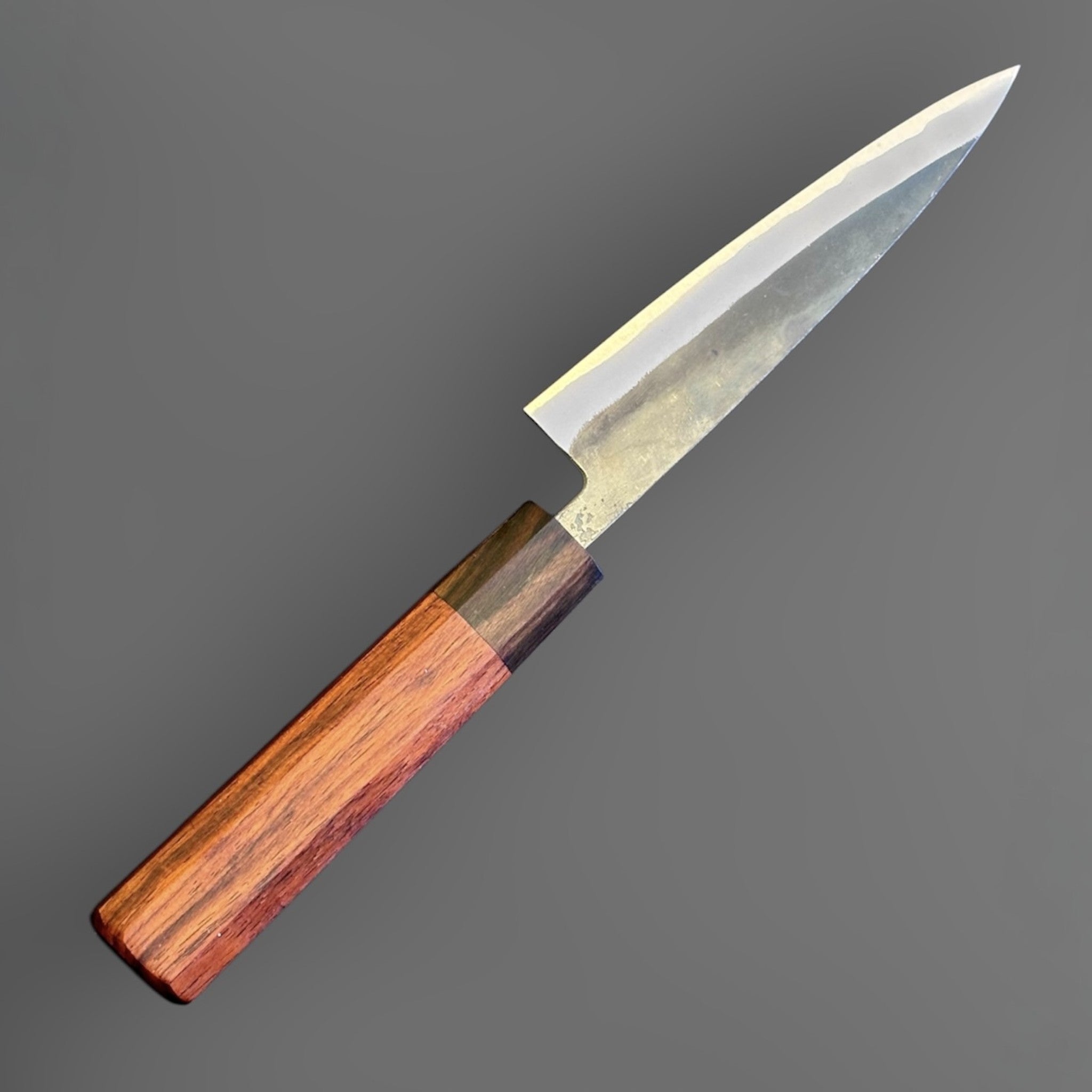 Tokushu Knife Rosewood Series White #2 Kurouchi 135 mm Japanese petty knife, angled reverse view with kurouchi blade finish and rosewood wa handle.