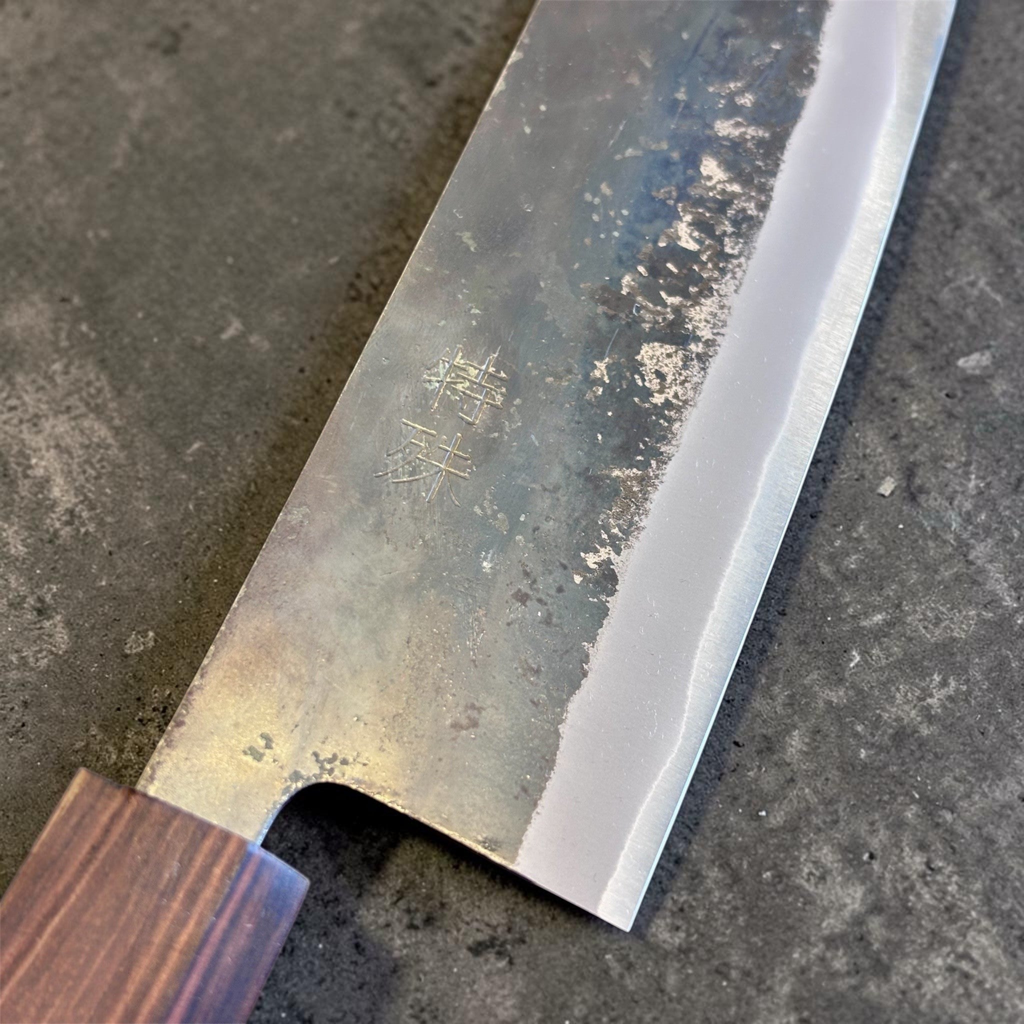 Tokushu Knife Rosewood Series White #2 Kurouchi 165 mm Japanese nakiri knife, close-up of the blade face with kanji engraving and kurouchi texture.