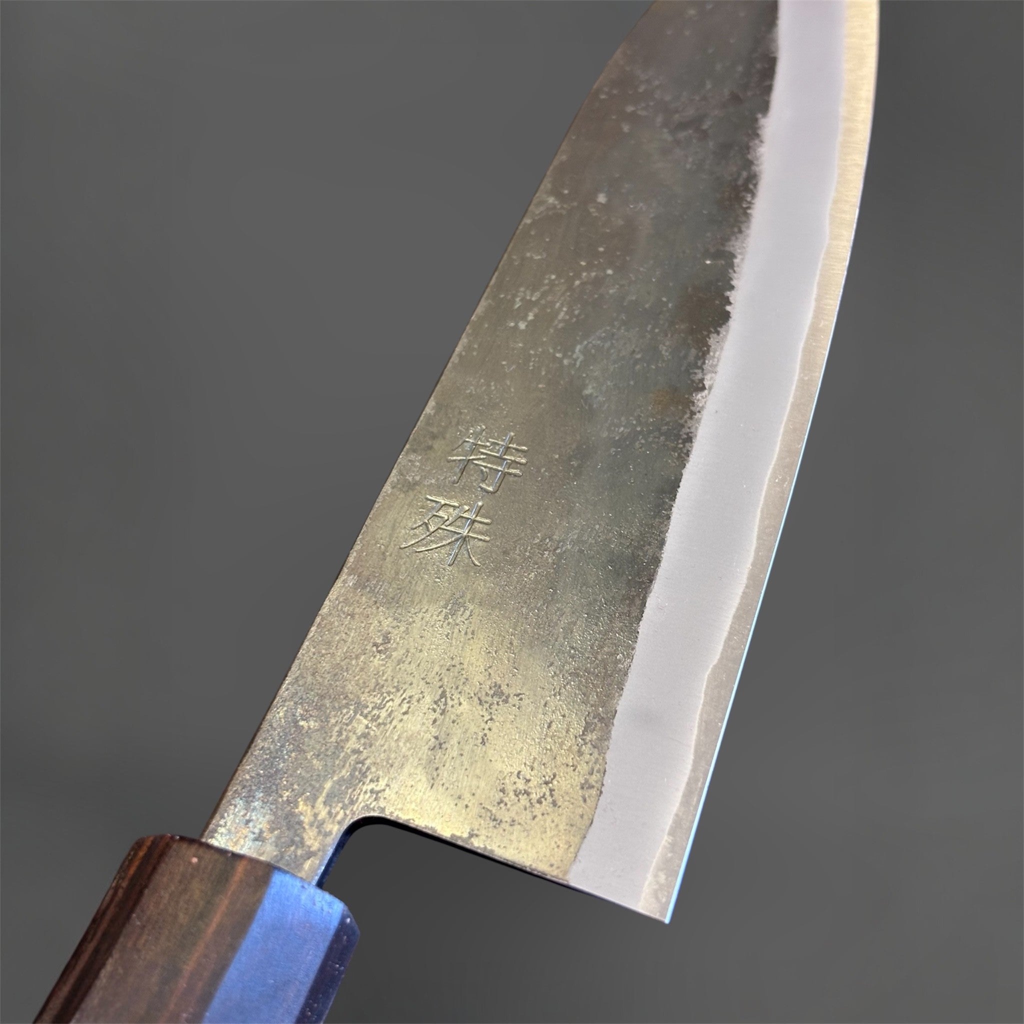 Tokushu Knife Rosewood Series White #2 Kurouchi 165 mm Japanese santoku knife, close-up of the blade face with kanji engraving and kurouchi texture.