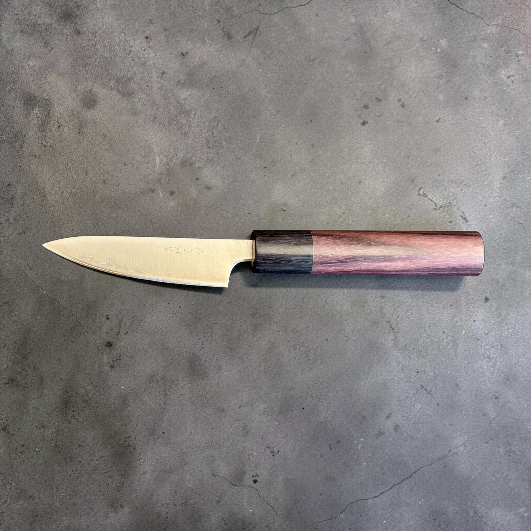 Tokushu Knife Stainless Clad Aogami Super Migaki Petty 80mm, reverse full profile with reddish wood handle and dark ferrule.