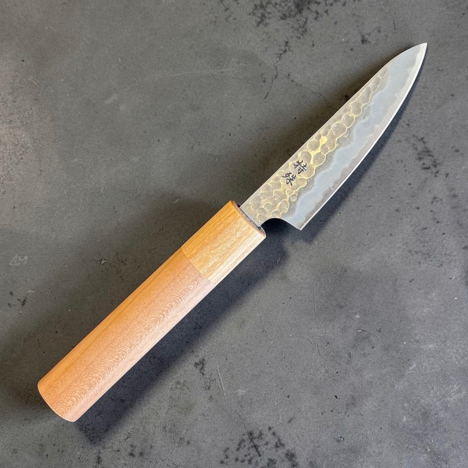 Blade and handle angle view of Tokushu Knife Stainless Clad White #2 Tsuchime Petty 80mm showing stainless cladding and tsuchime texture.