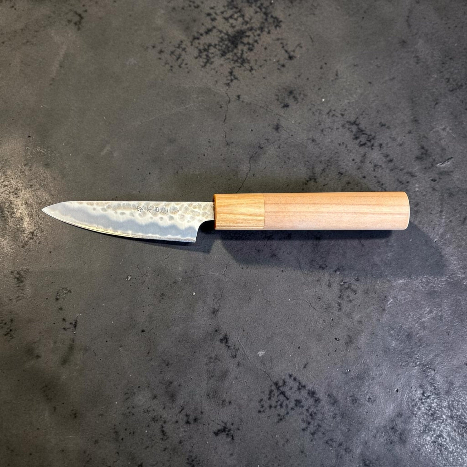 Left-side full profile of Tokushu Knife Stainless Clad White #2 Tsuchime Petty 80mm with light wood handle.