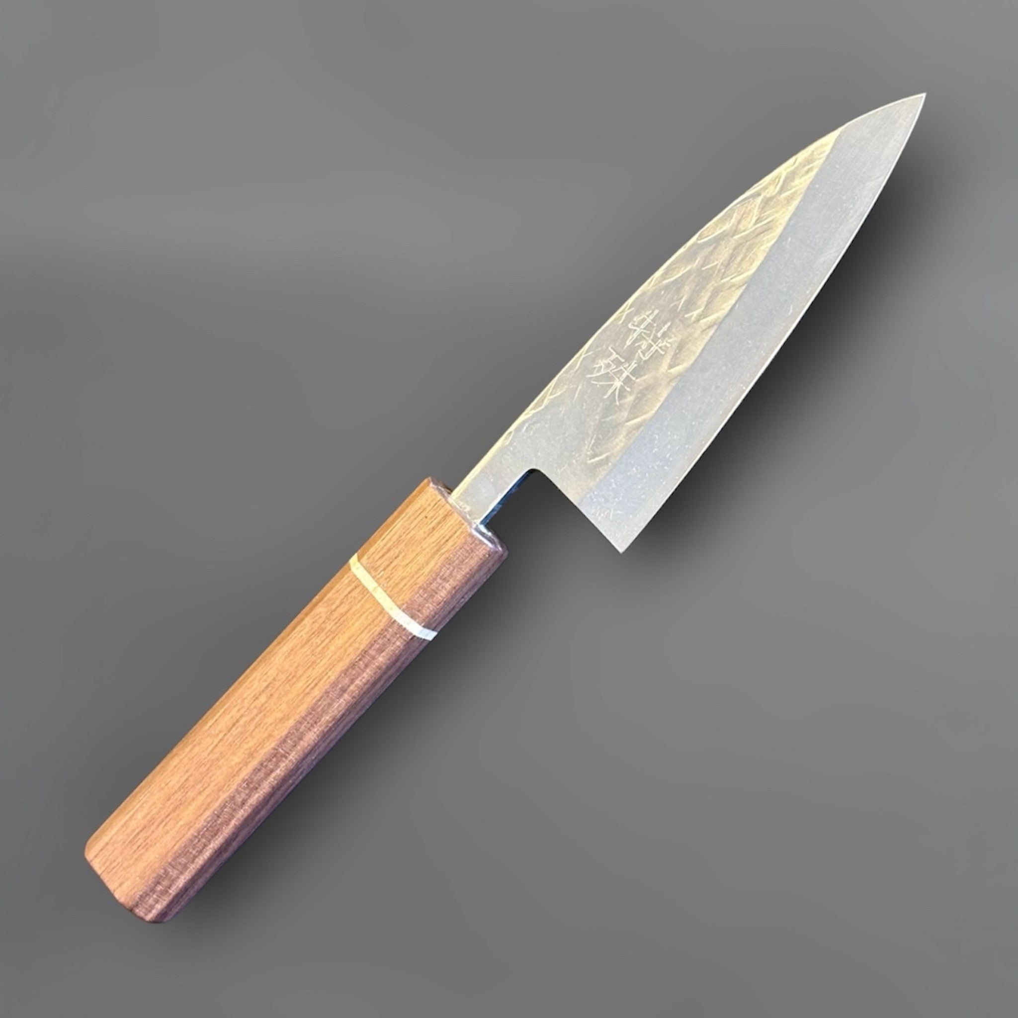 Tokushu Knife Tsuchime SLD 105 mm Tall Petty Ajikiri, angled view highlighting the compact tall petty shape and octagonal wood handle.