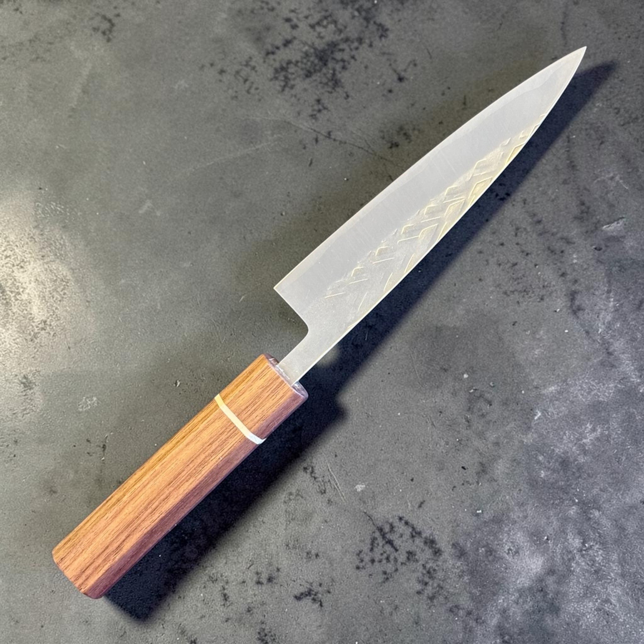 Tokushu Knife Tsuchime SLD 135 mm Petty, angled front view highlighting the compact pointed petty blade and wood wa handle.