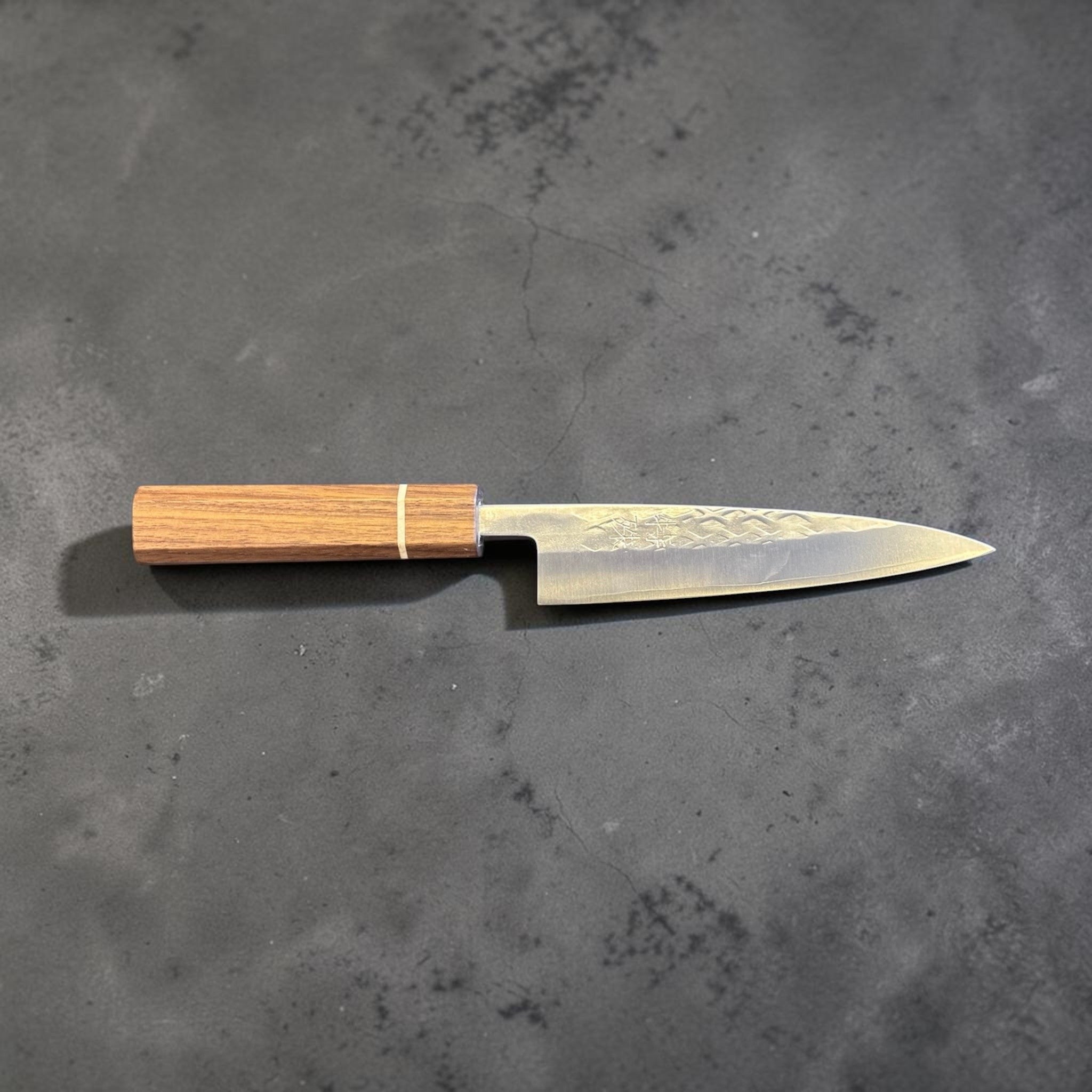 Tokushu Knife Tsuchime SLD 135 mm Petty, full profile view showing the narrow petty shape, hammered finish, and wooden wa handle.