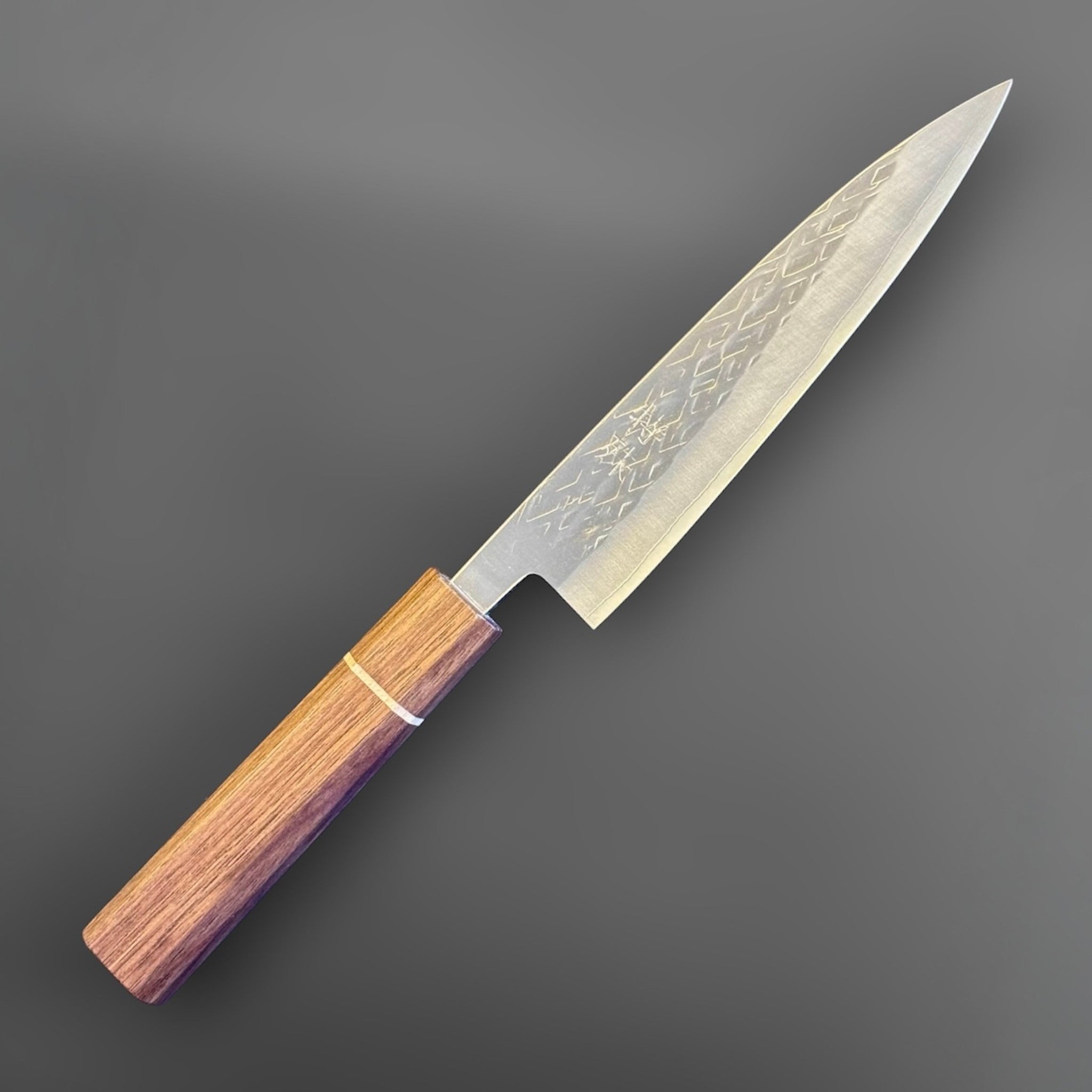 Tokushu Knife Tsuchime SLD 165 mm Hiraki Petty, angled front view highlighting the narrow pointed blade and octagonal wood wa handle.
