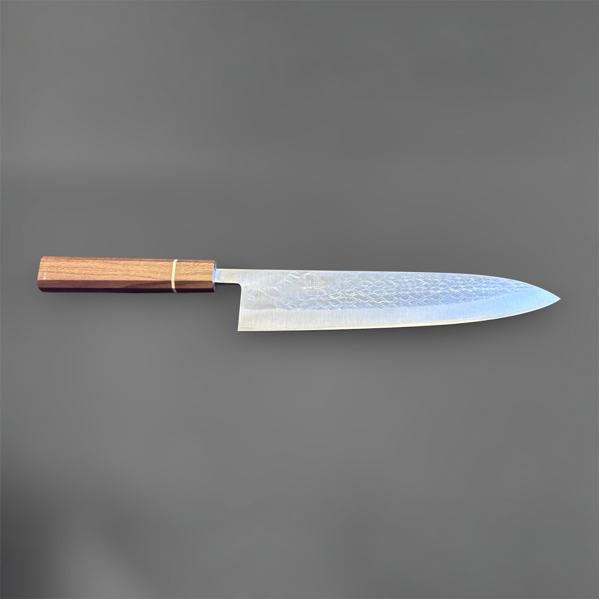 Tokushu Knife Tsuchime SLD Gyuto 240 mm, full profile view highlighting the extended gyuto profile, tsuchime finish, and octagonal wood handle.