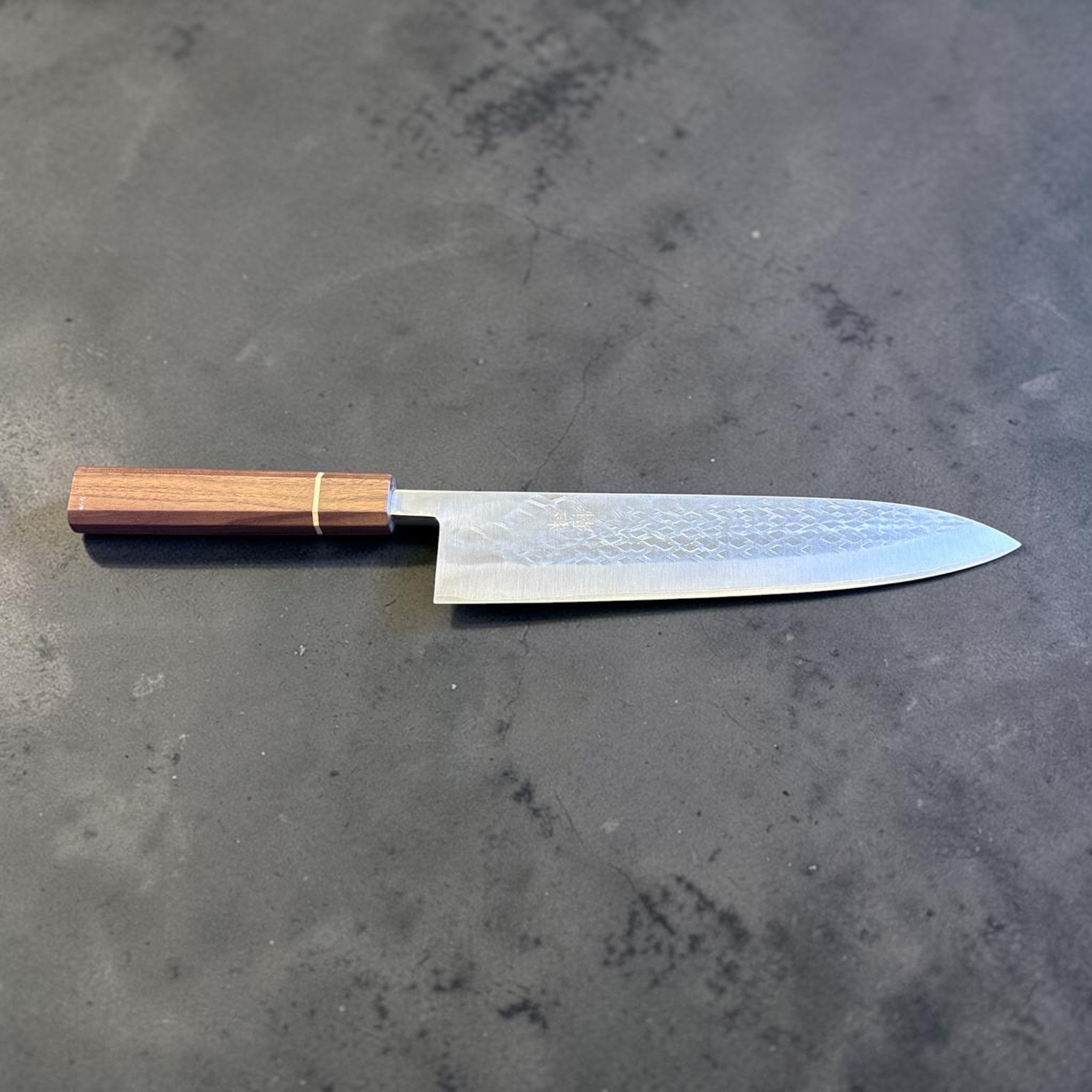 Tokushu Knife Tsuchime SLD Gyuto 240 mm, full profile view highlighting the extended gyuto profile, tsuchime finish, and octagonal wood handle.