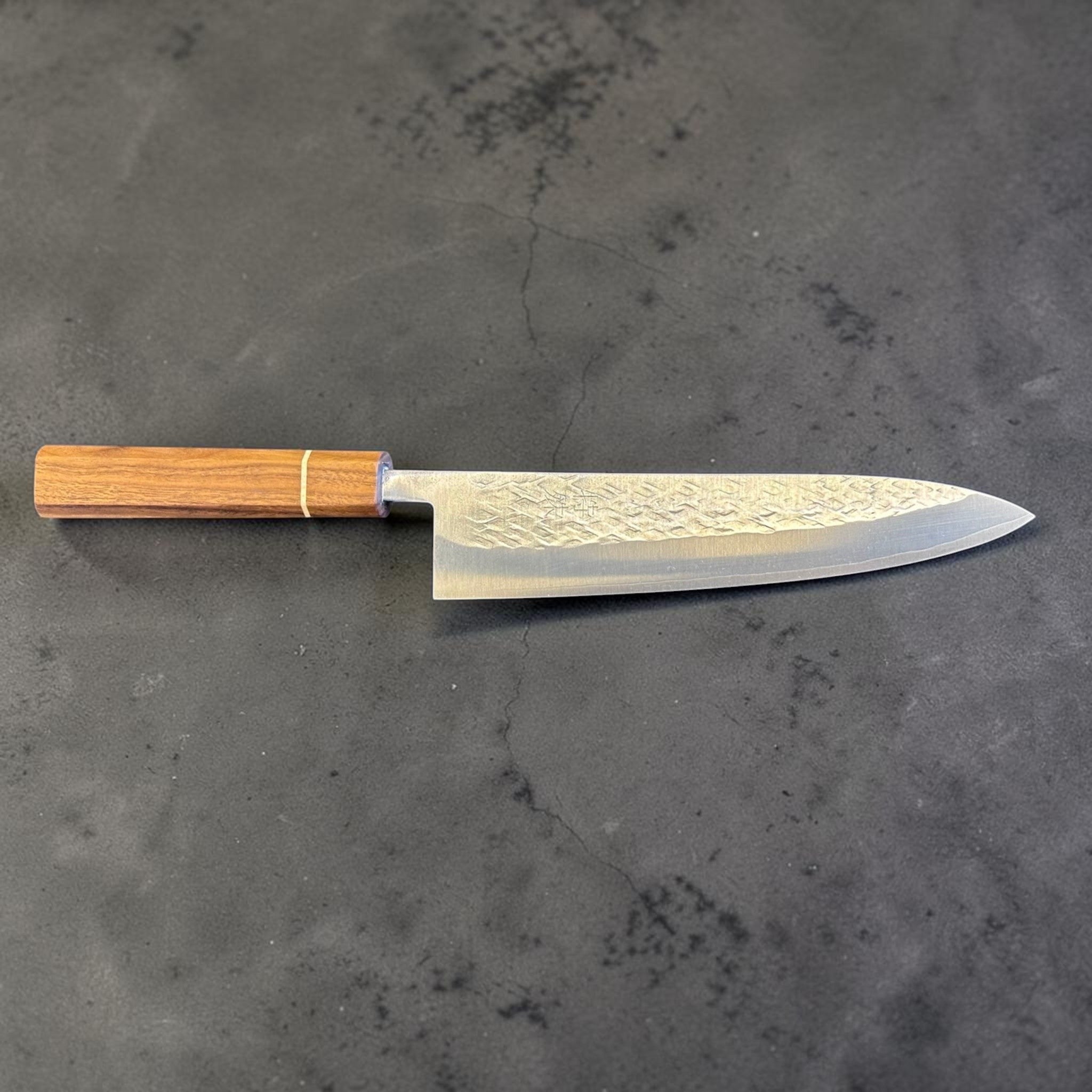 Tokushu Knife Tsuchime SLD Gyuto 210 mm, full profile view highlighting the long gyuto shape, tsuchime finish, and wood wa handle.