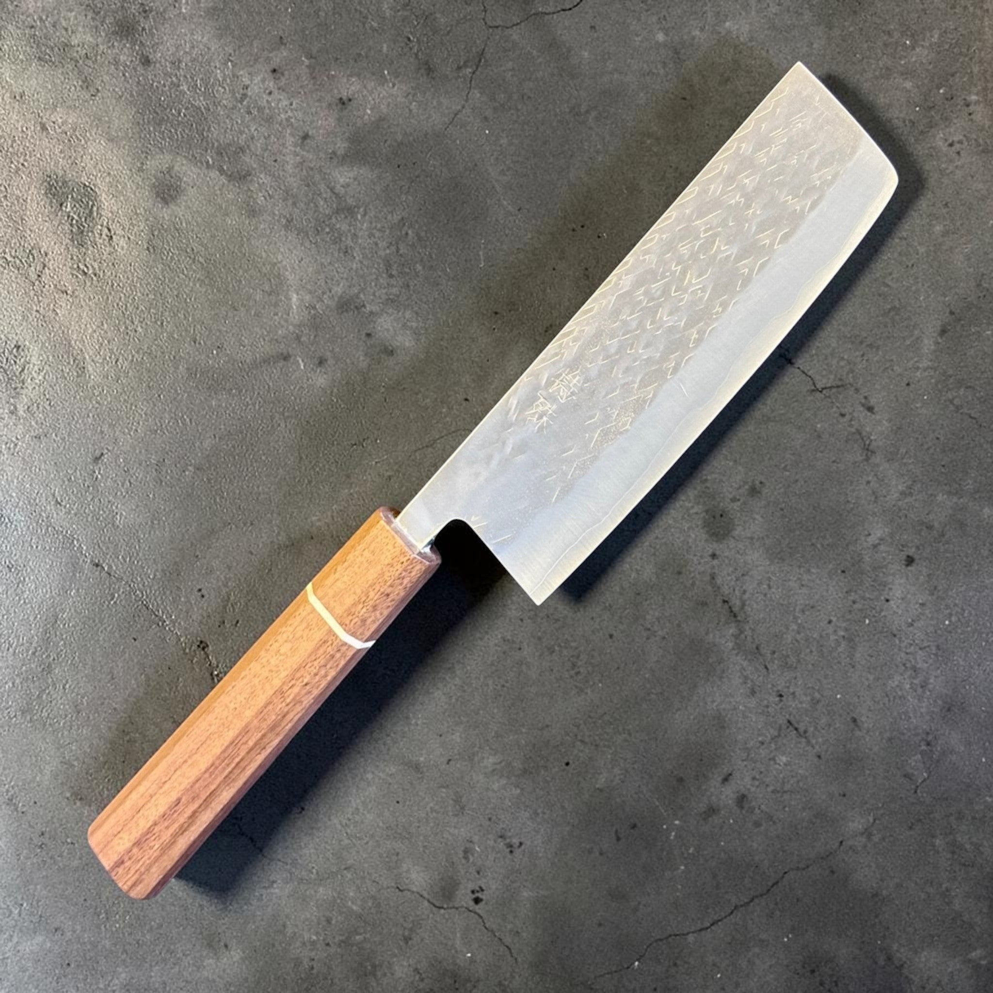 Tokushu Knife Tsuchime SLD Nakiri, angled front view highlighting the tall rectangular vegetable knife profile and wood wa handle.