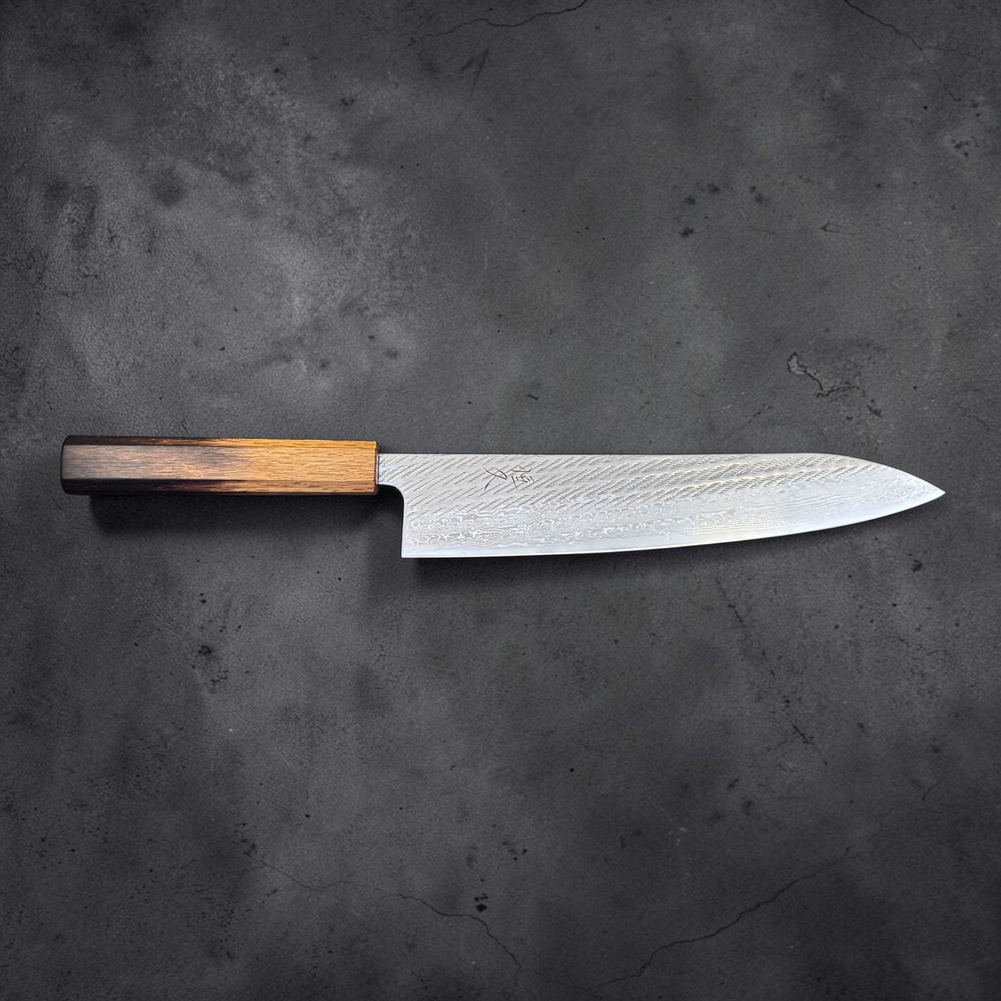 Tsunehisa AUS-10 Nawame Gyuto 240 mm with burnt oak handle, opposite side profile view showing polished edge and textured finish.