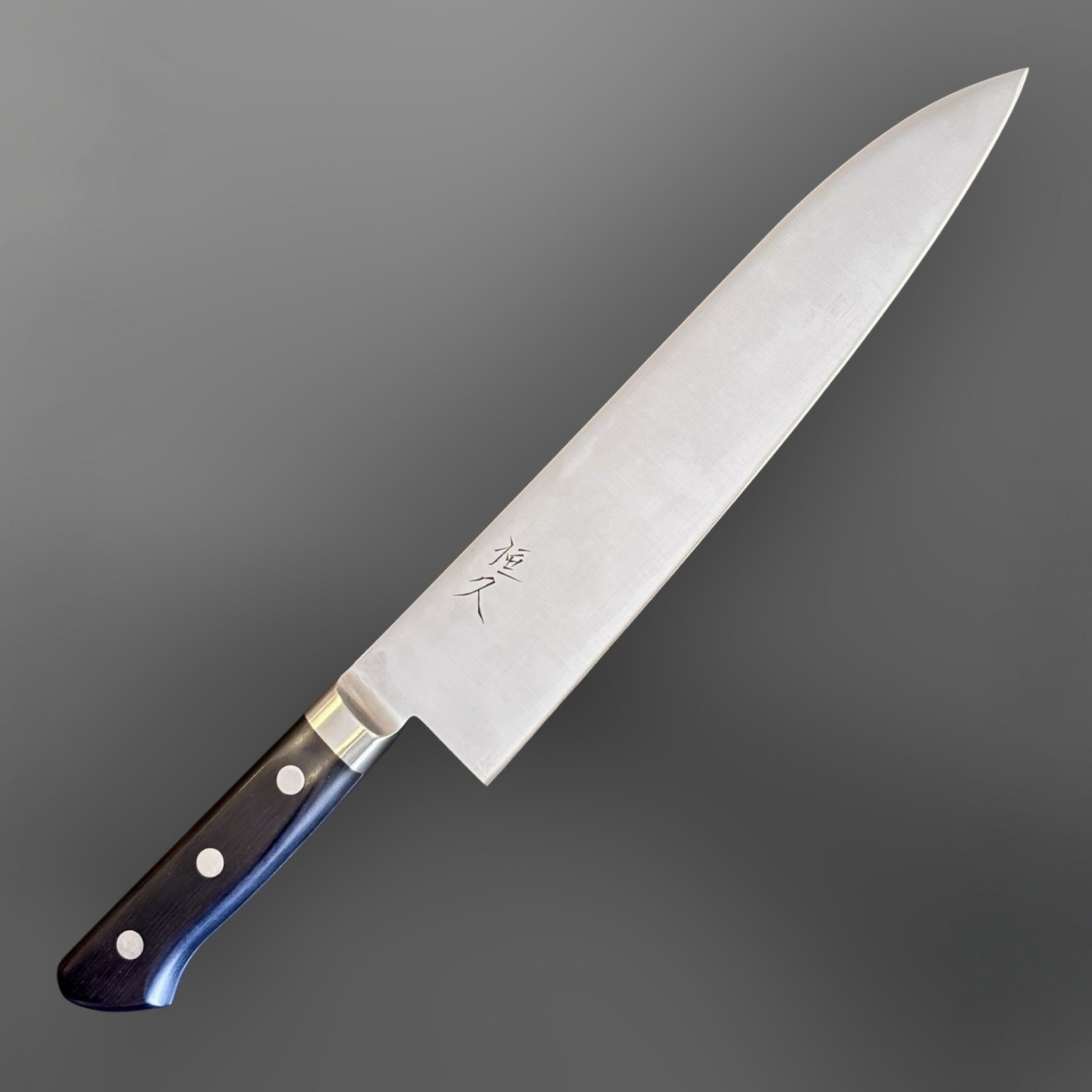 Tsunehisa Mono AUS-8 Gyuto 240 mm with black Western handle, angled product view highlighting black Western handle and stainless blade.