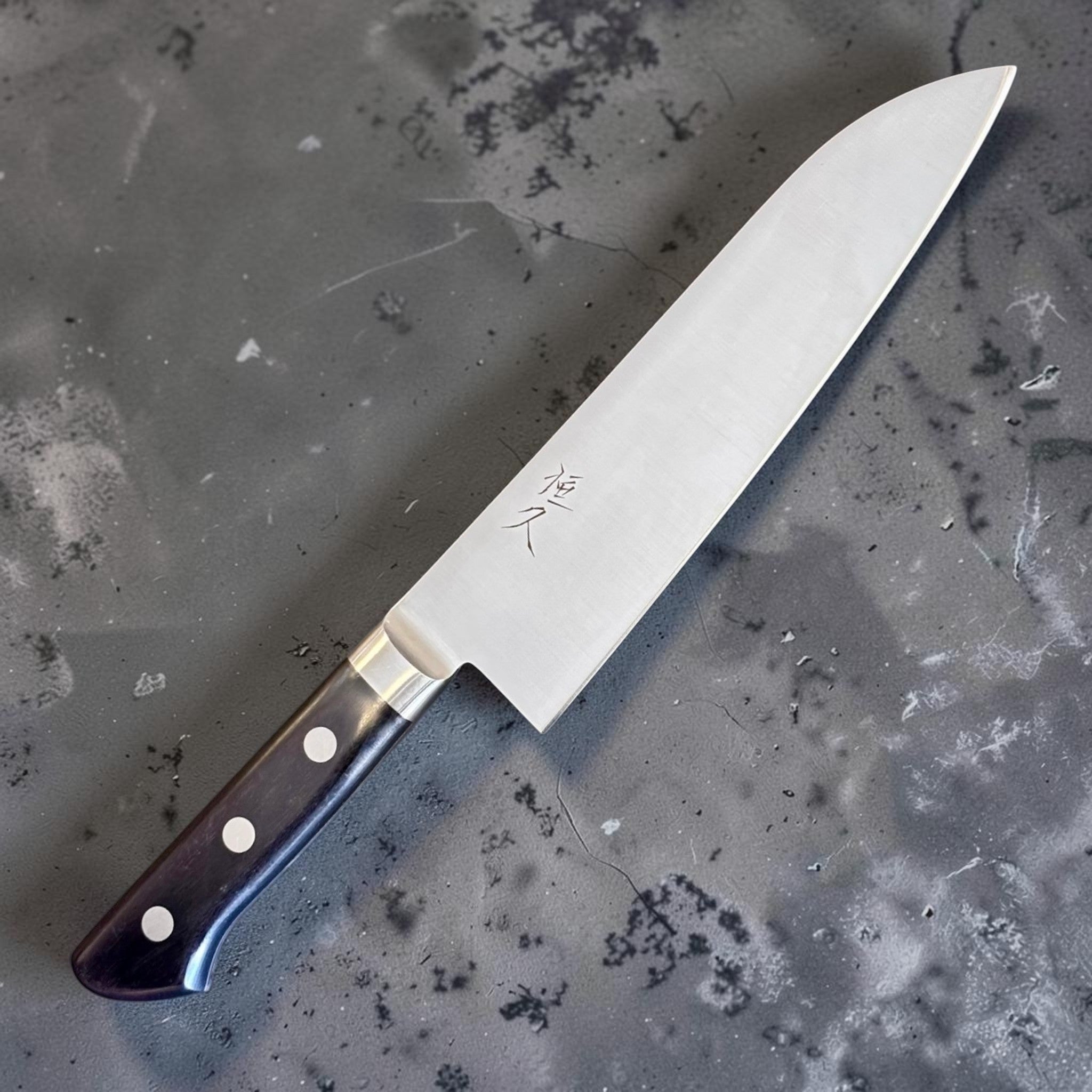Tsunehisa Mono AUS-8 Santoku 165 mm with black Western handle, angled hero view showing the kanji mark on the blade.