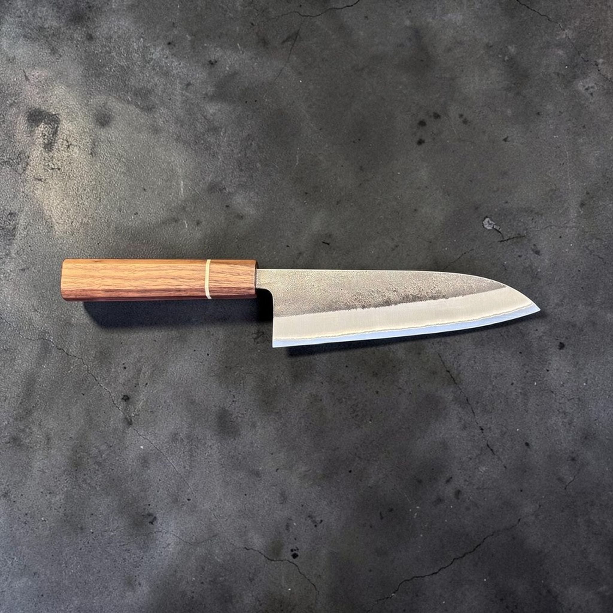 Yoshikane Nashiji Kurouchi Santoku with Sanjo walnut handle, side profile view showing the santoku blade shape.