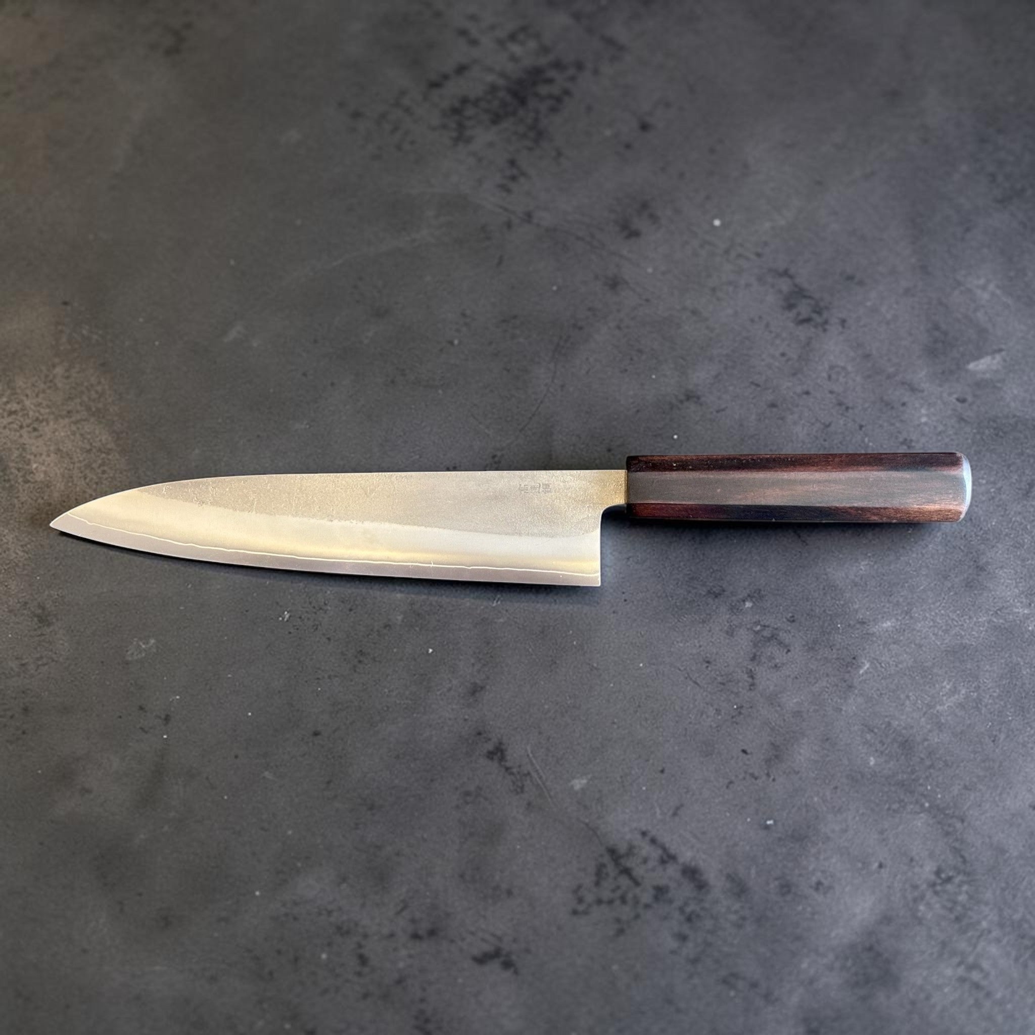 Yoshikane SKD Nashiji Gyuto 210 mm with mono ebony handle, reverse full side profile showing thin edge line.